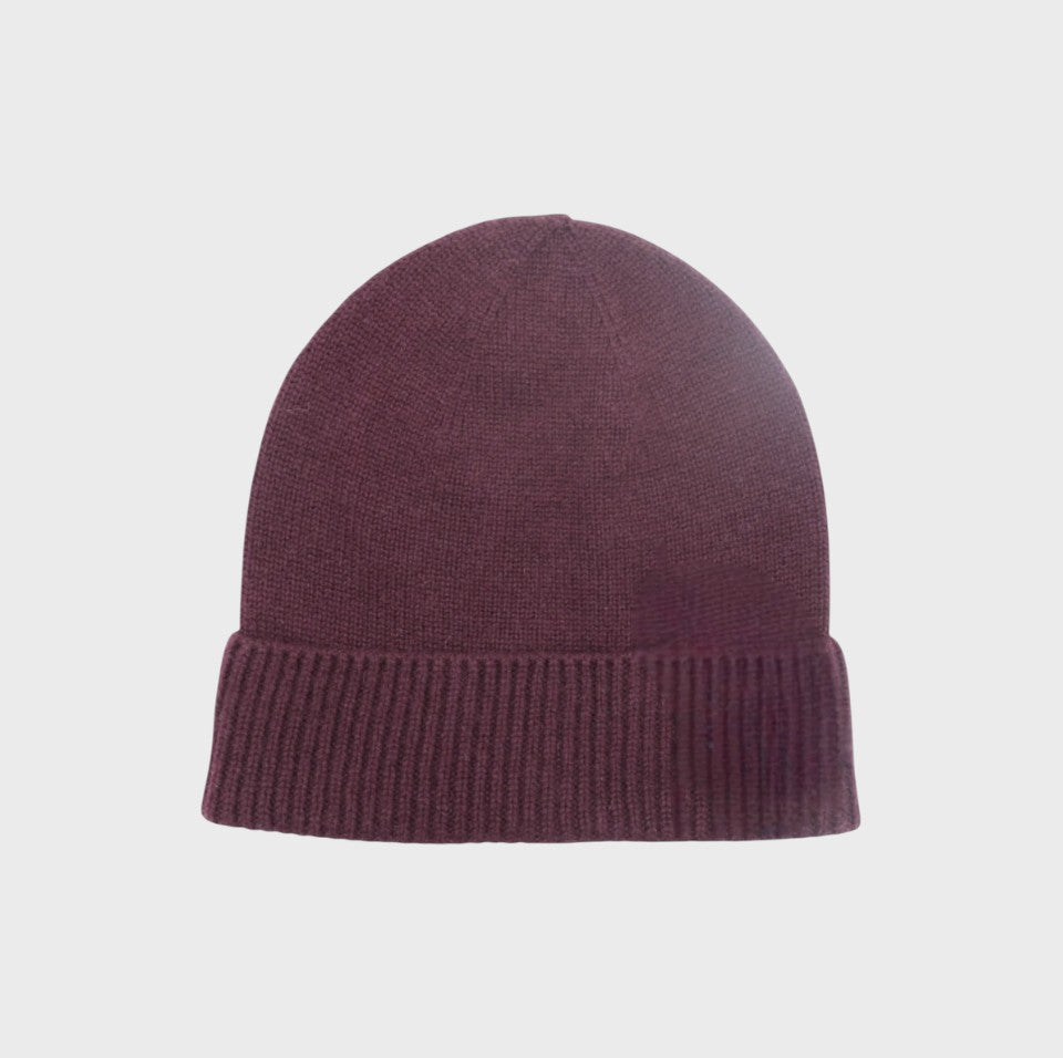Purple cashmere knit bonnet on a light gray background