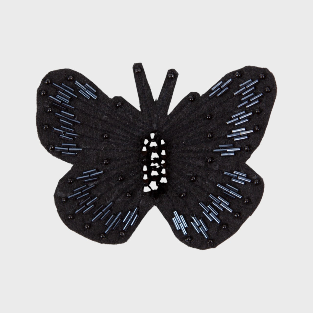An embroidered Brooch representing a black butterfly with black details. 