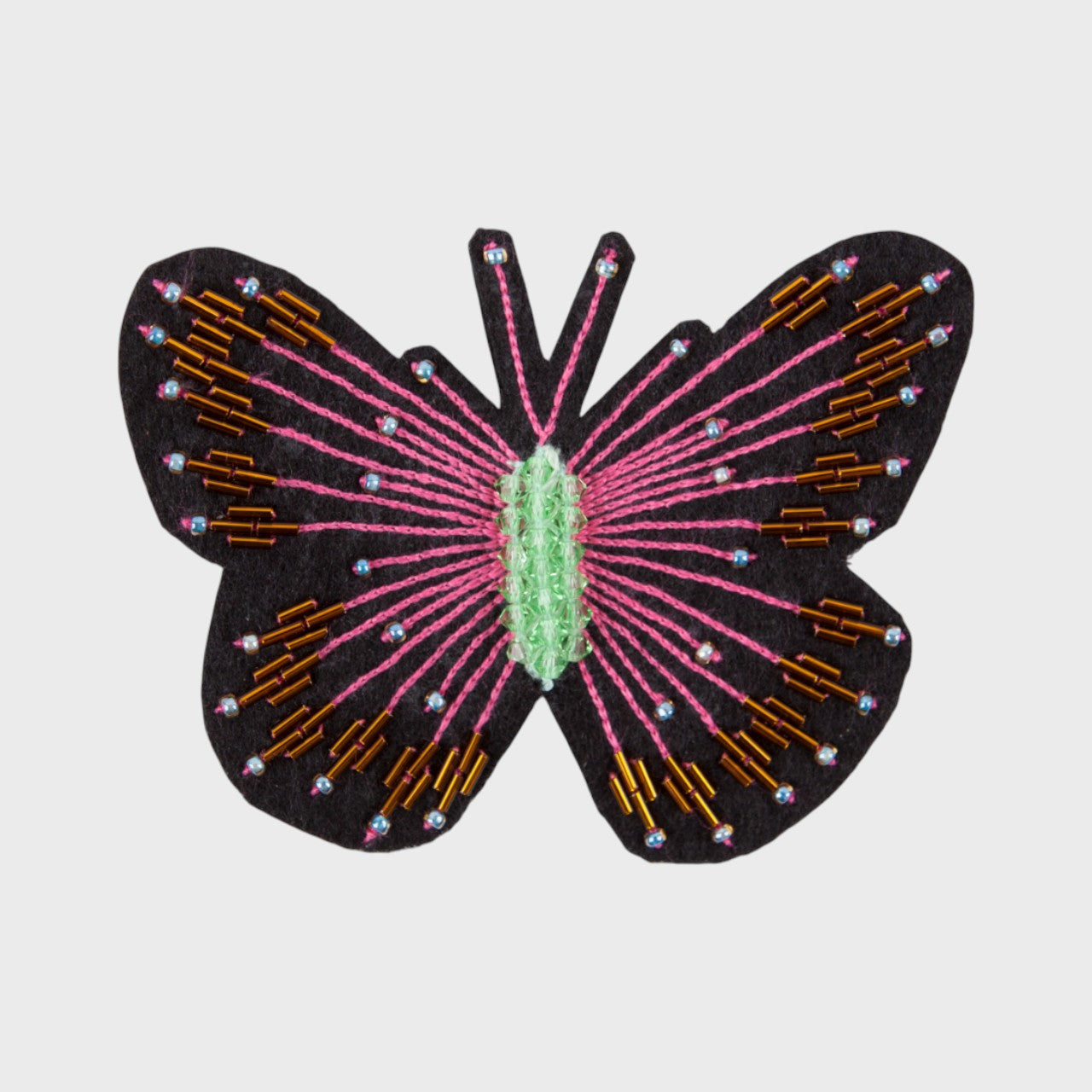 An embroidered brooch representing a black butterfly with pink and golden details. 