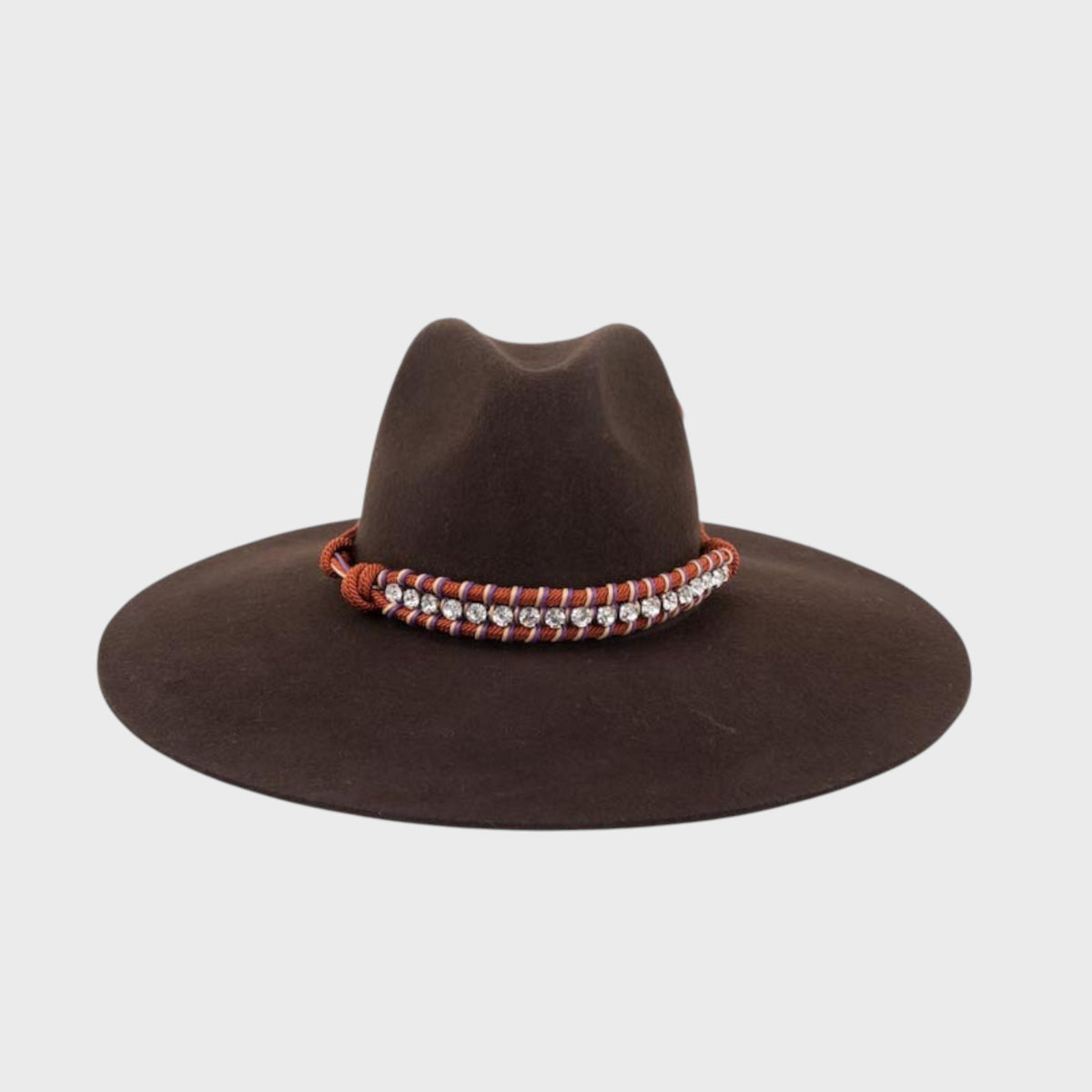 Brown velvet hat with decorative band on a light gray background