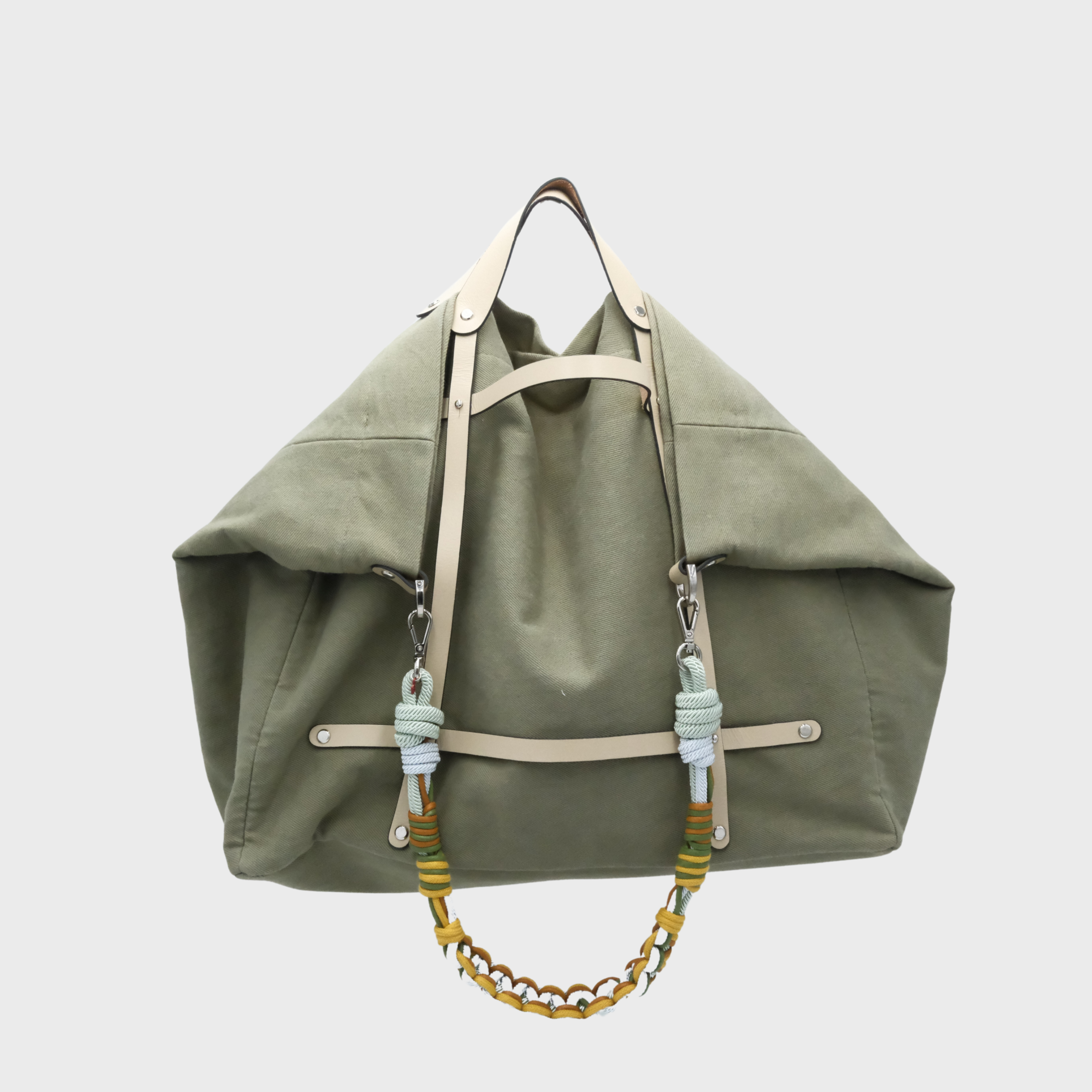 An olive green canvas Candide weekender with light beige leather straps and a colorful Alice Strap in light blue, green, and yellow.