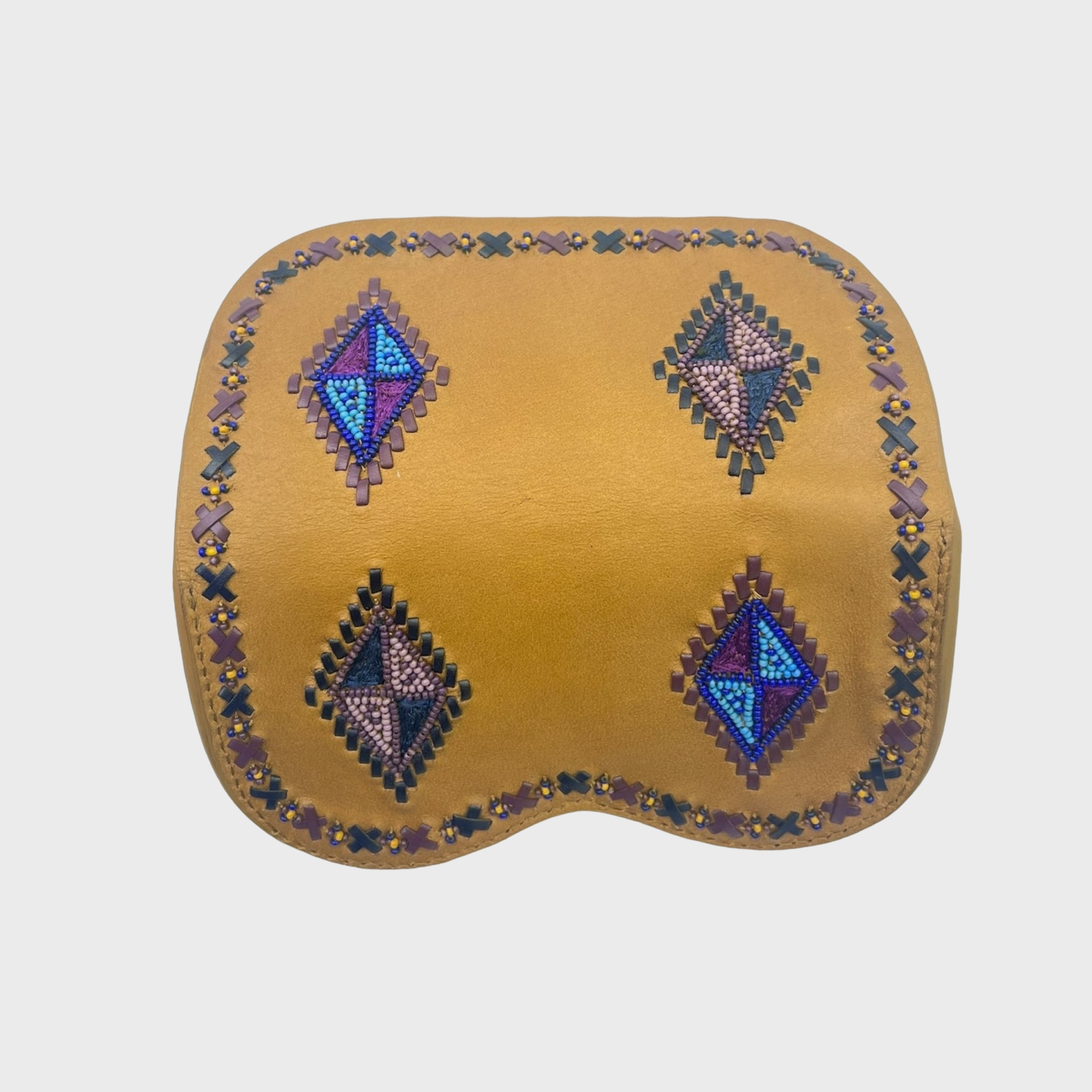 The back of a mustard yellow leather glasses case with four diamond-shaped geometric beadwork motifs in blue, purple, and black, and a matching beaded border, shown on a light gray background.