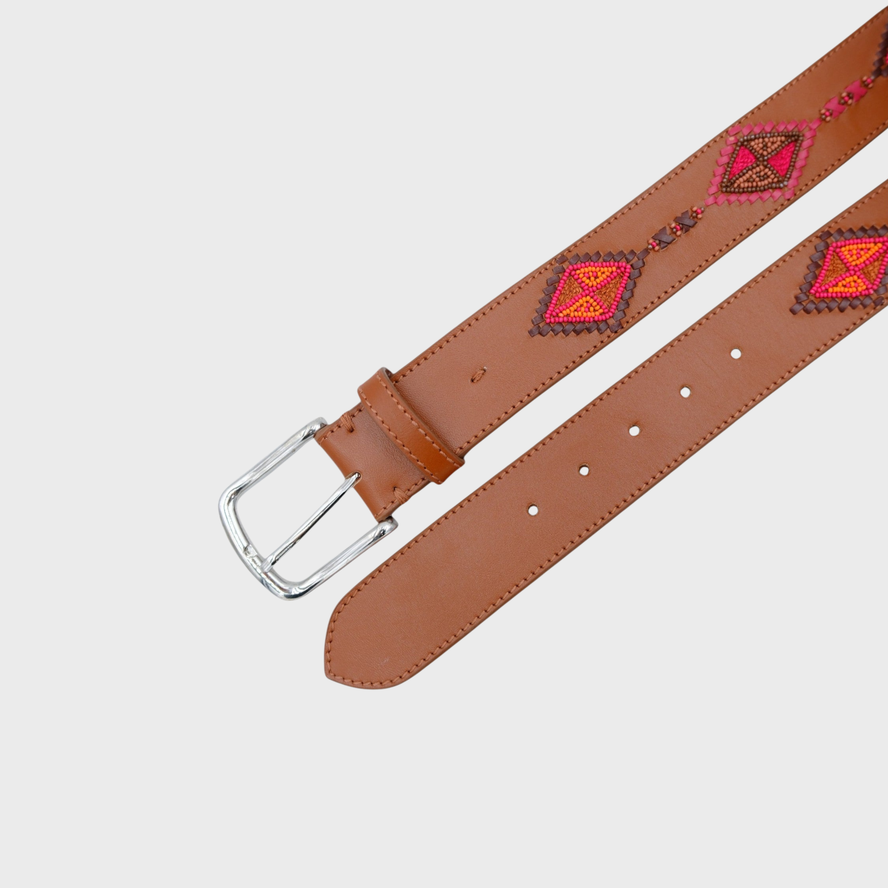 A brown leather belt with a silver buckle, featuring a geometric pattern in red, orange, and pink on the strap.