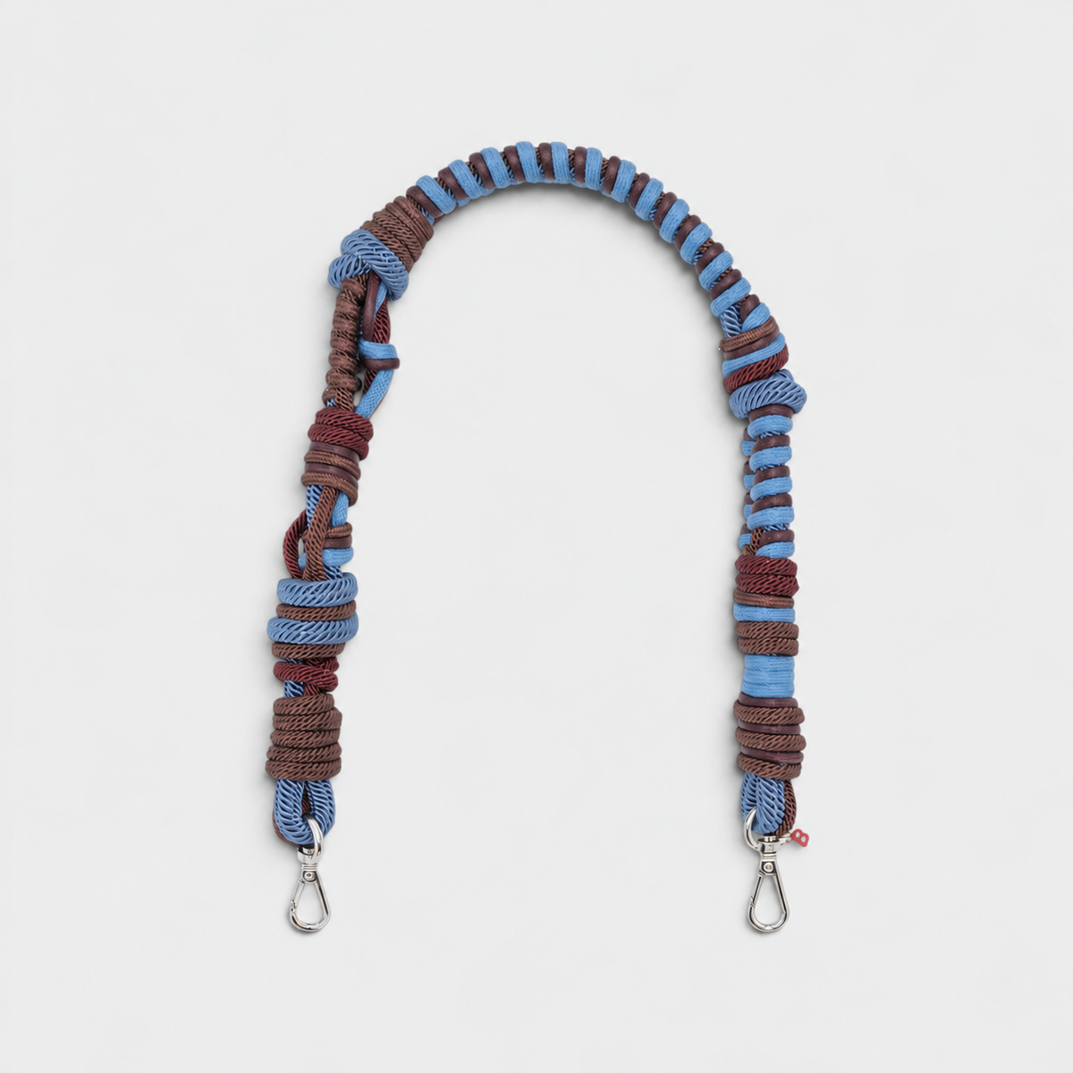 A brown and blue woven macramé bag strap. 