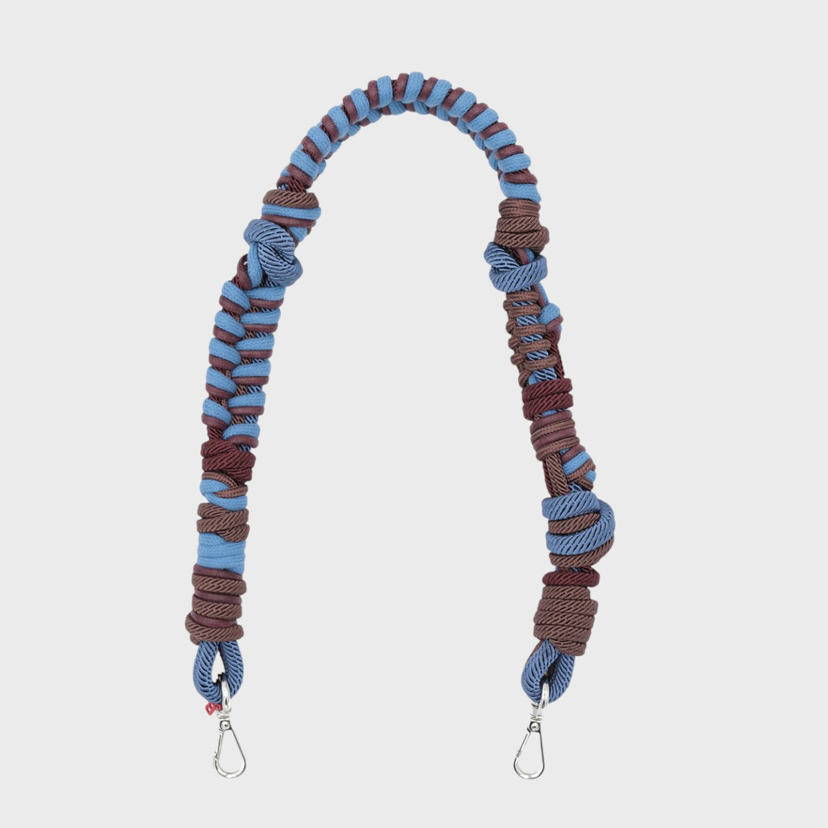 A brown and blue woven macramé bag strap. 