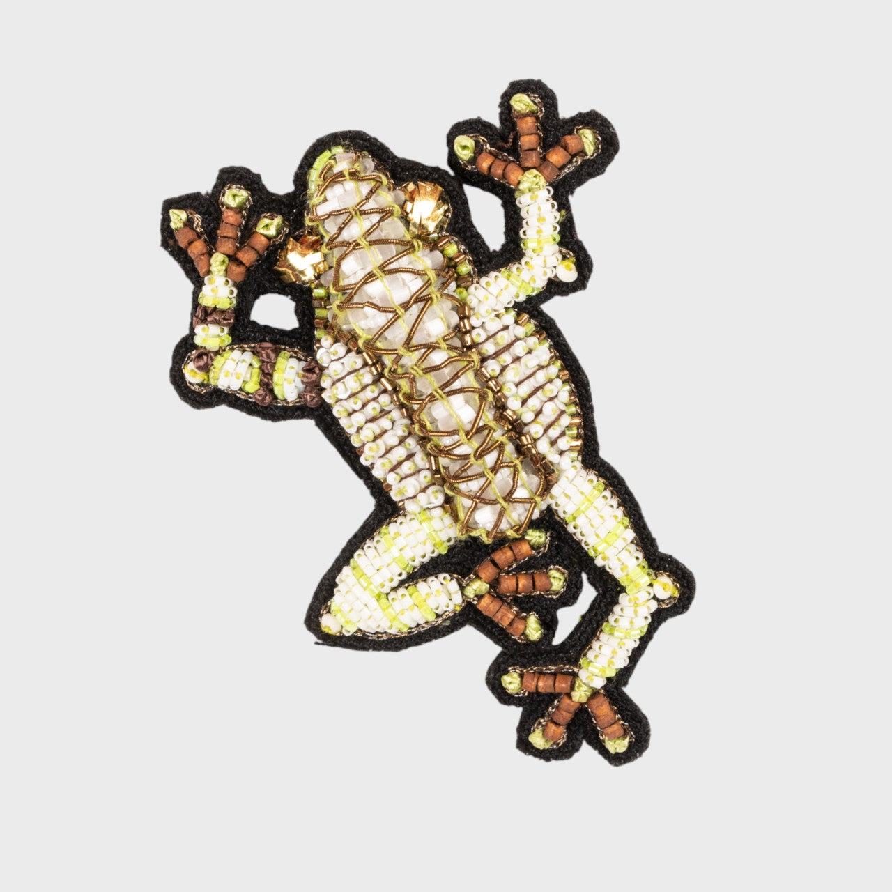 An embroidered brooch representing a green dendrobate. 