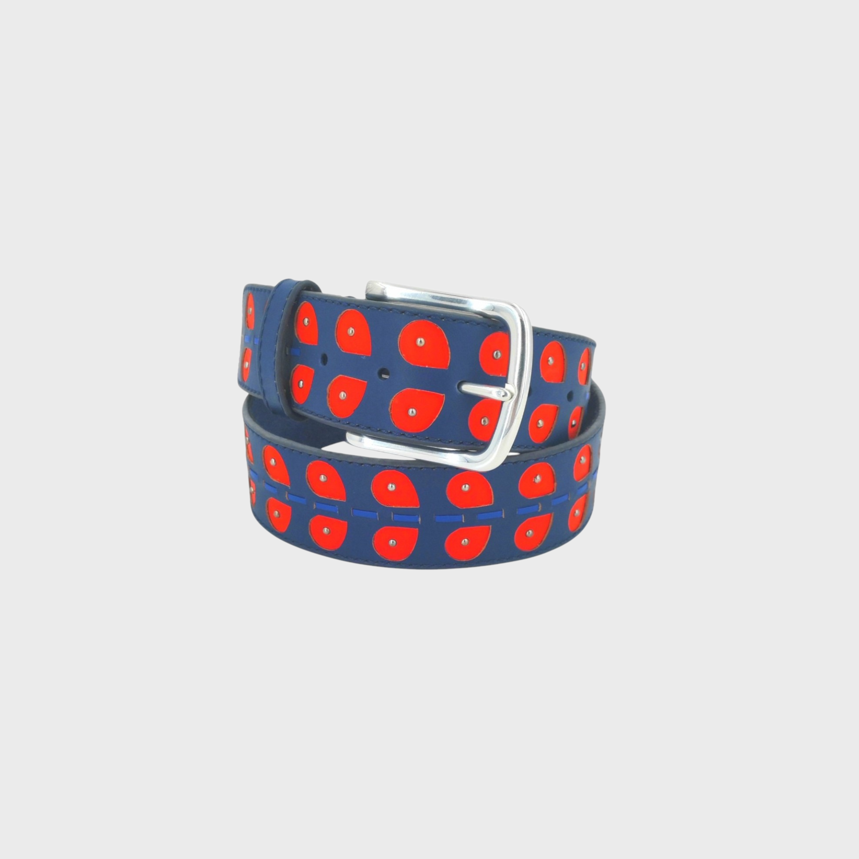 A navy blue leather belt with a repeating pattern of red leaves, featuring a silver metal buckle, coiled on a light gray background.