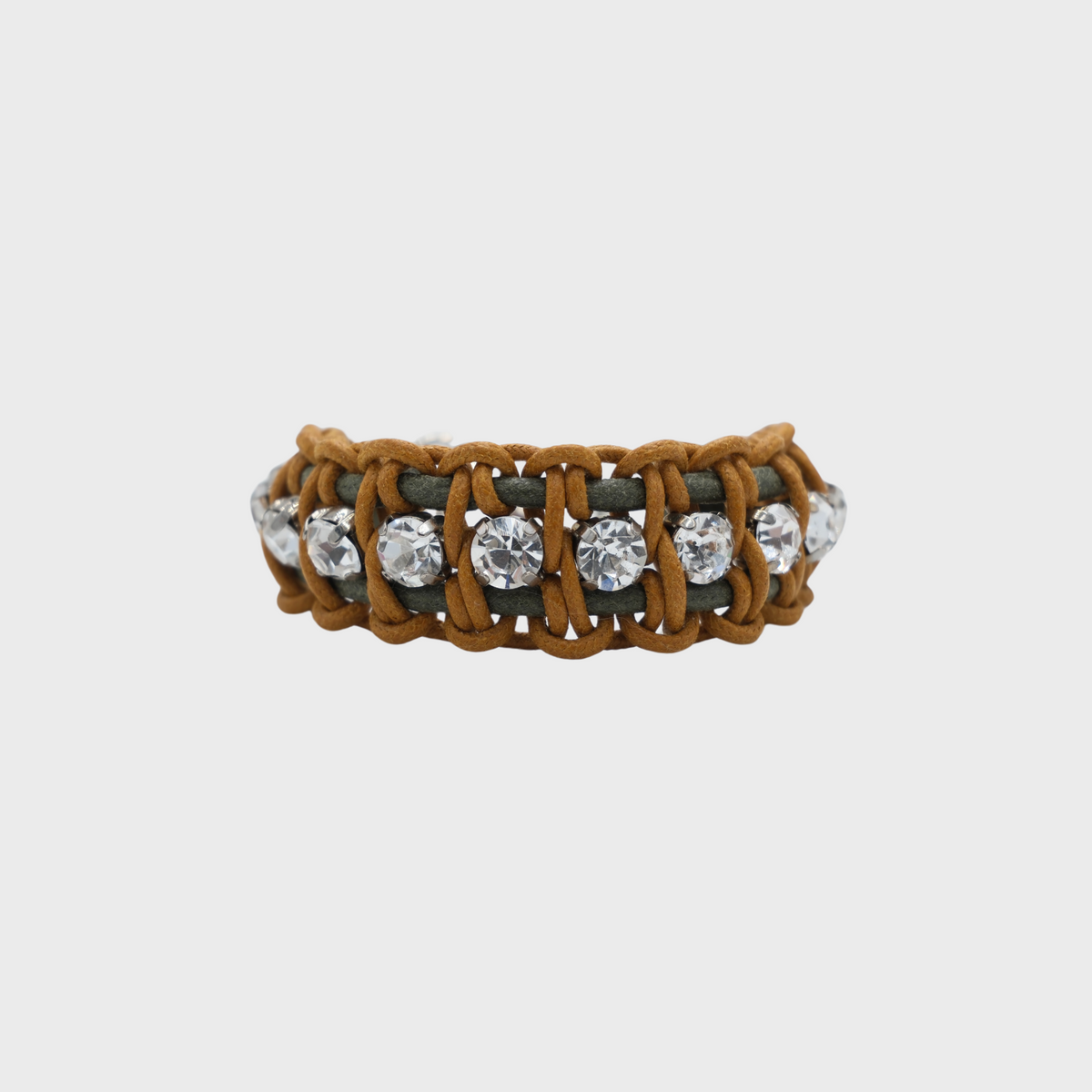 A woven brown macrame bracelet with clear round-cut rhinestones set in a dark gray metal frame, shown against a light gray background.