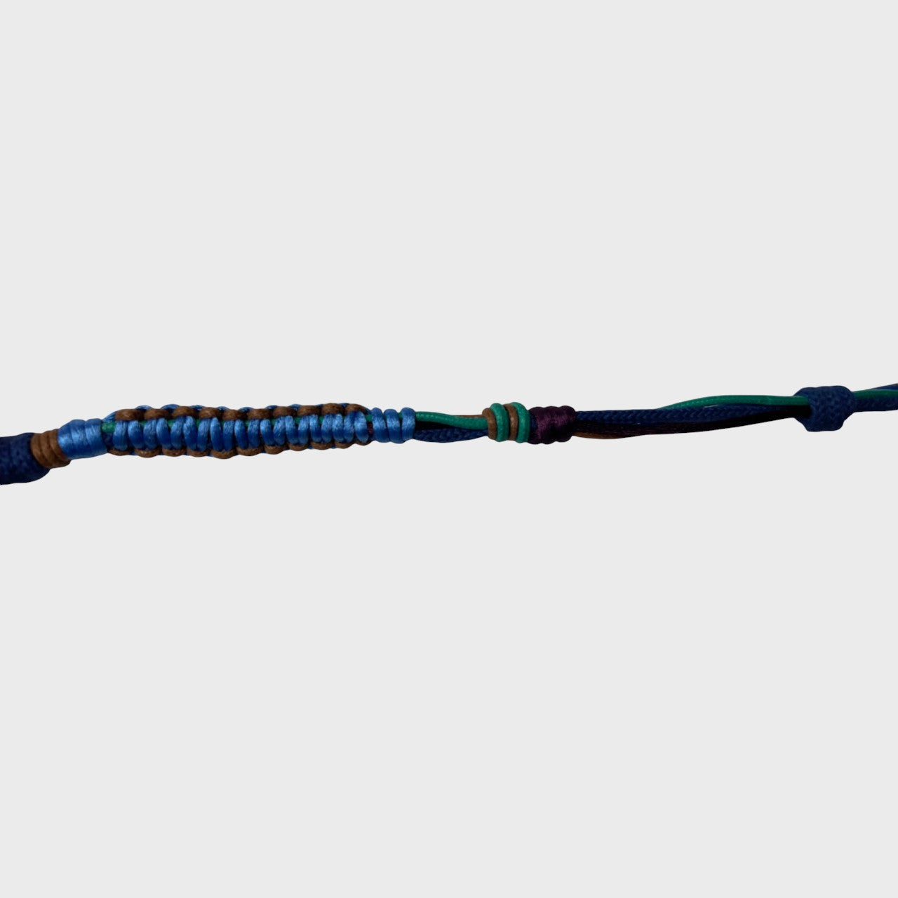 Eyeglasses holder with blue, purple, brown and green woven pattern on a white background