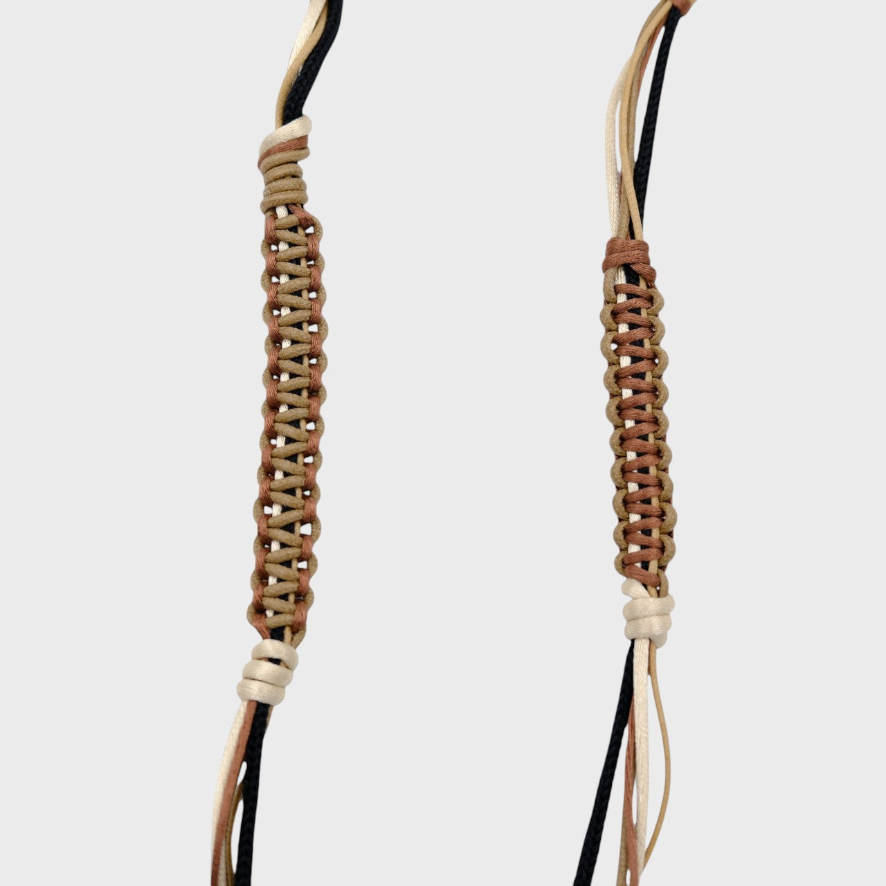 Detail of the brown, beige and black phone lanyard. 