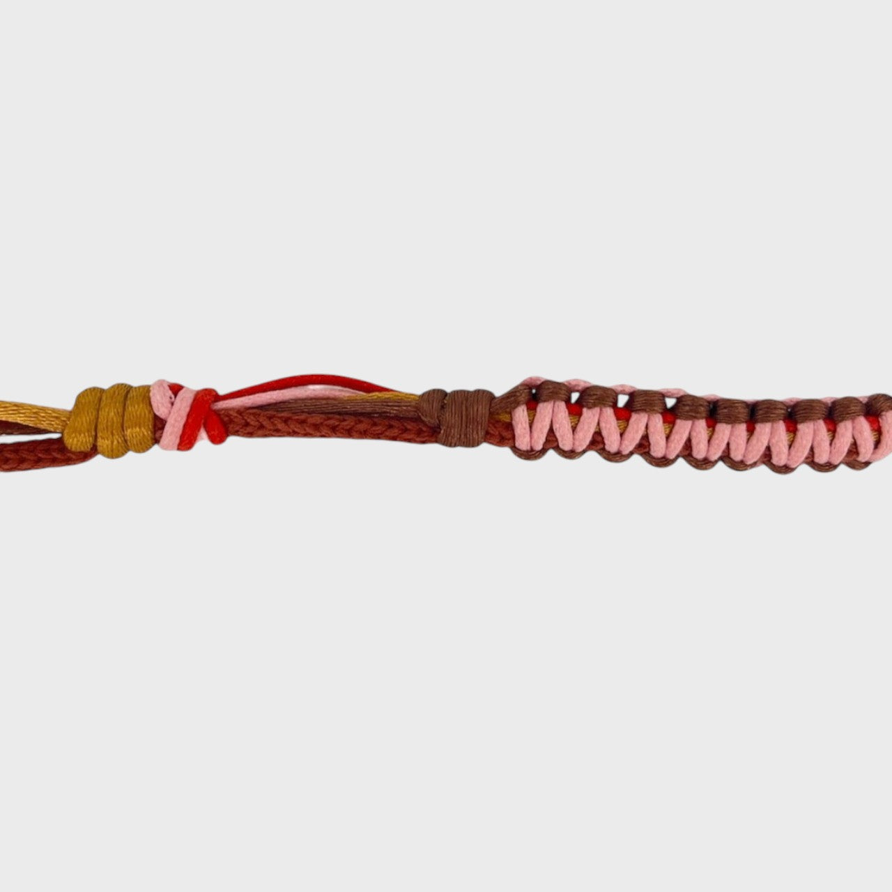 Eyeglasses holder with light pink, brown, red and yellow woven pattern on a white background
