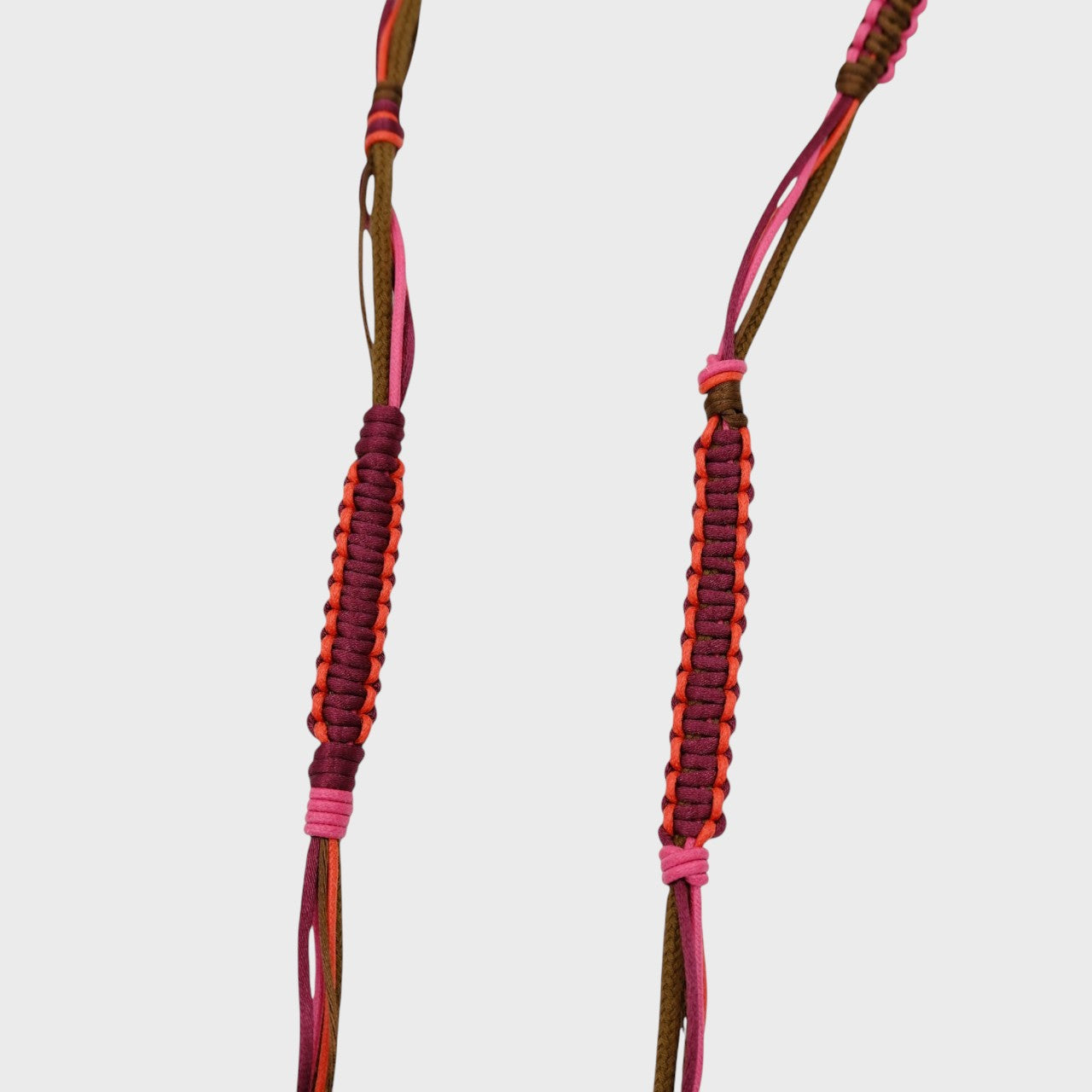 Detail of the pink, red an brown phone lanyard. 