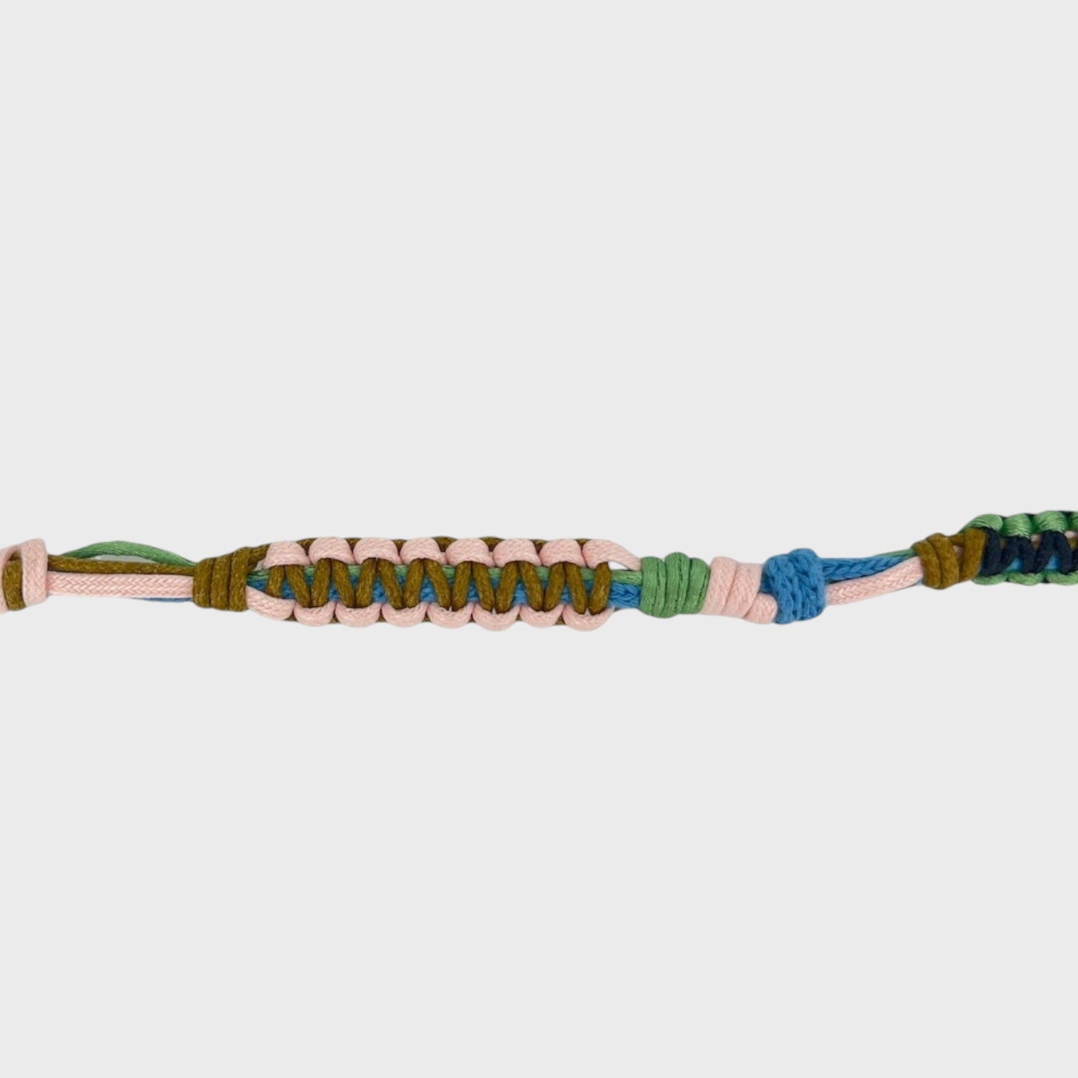 Eyeglasses holder with pink, blue, brown and green woven pattern on a white background
