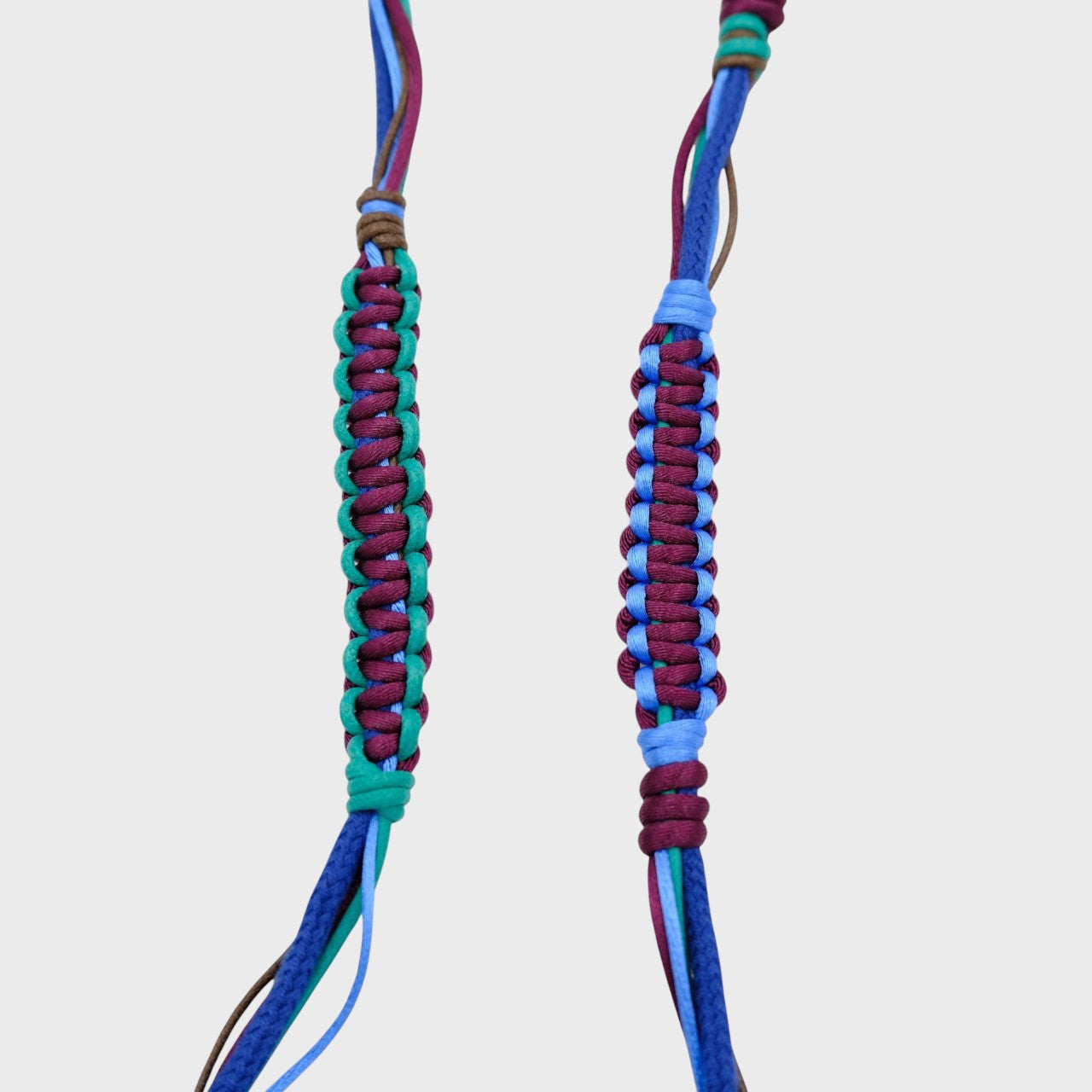 Detail of the purple, blue, green and brown phone lanyard.