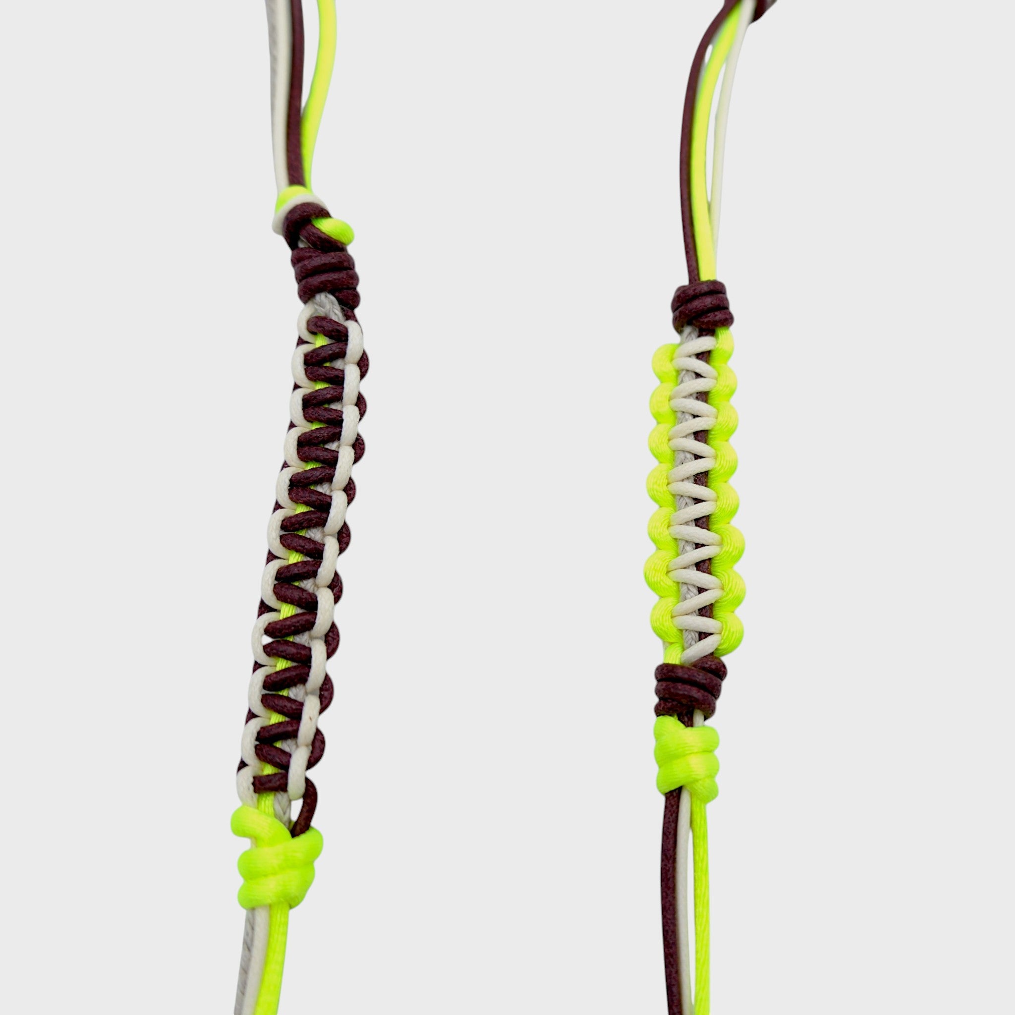 Detail of the beige, neon yellow and brown phone lanyard. 