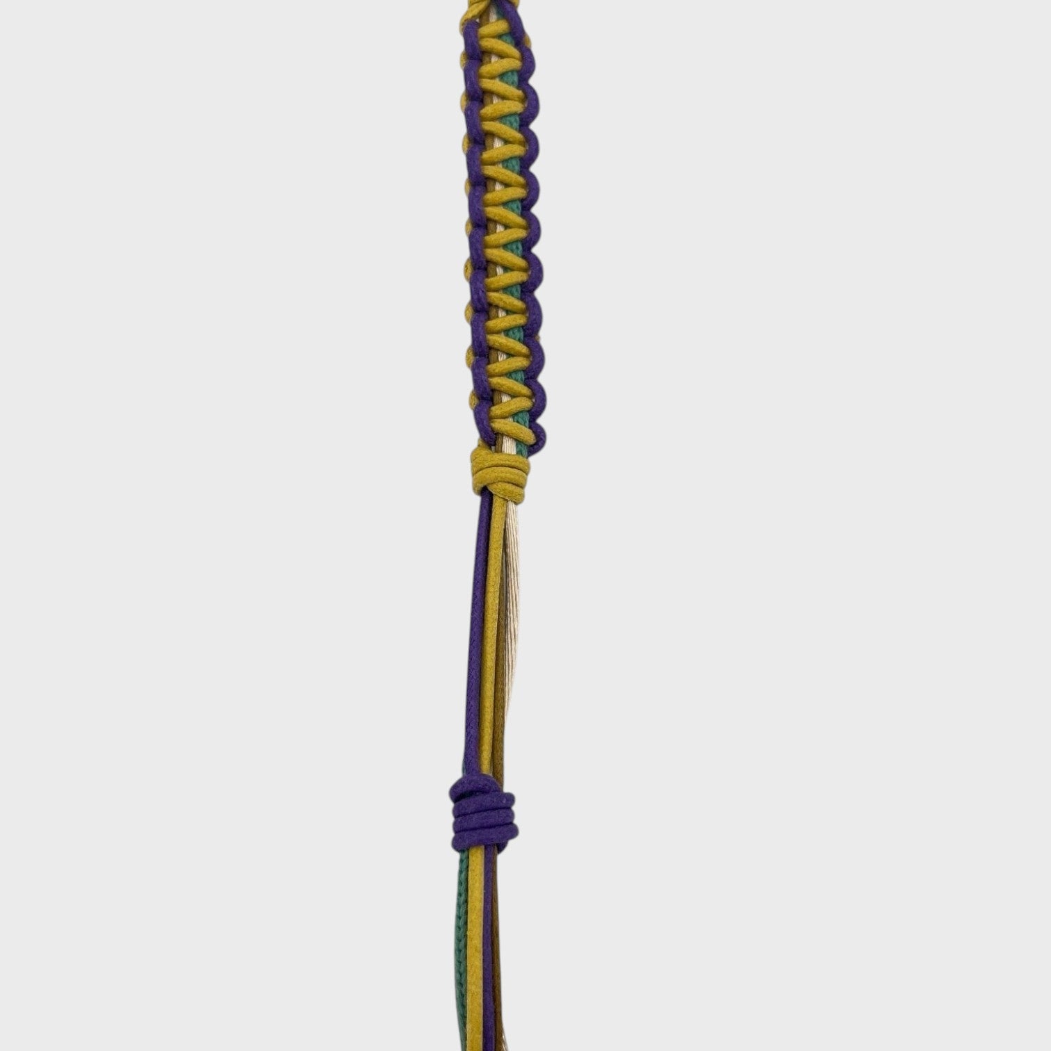 Detail of the yellow, purple, green and beige phone lanyard. 