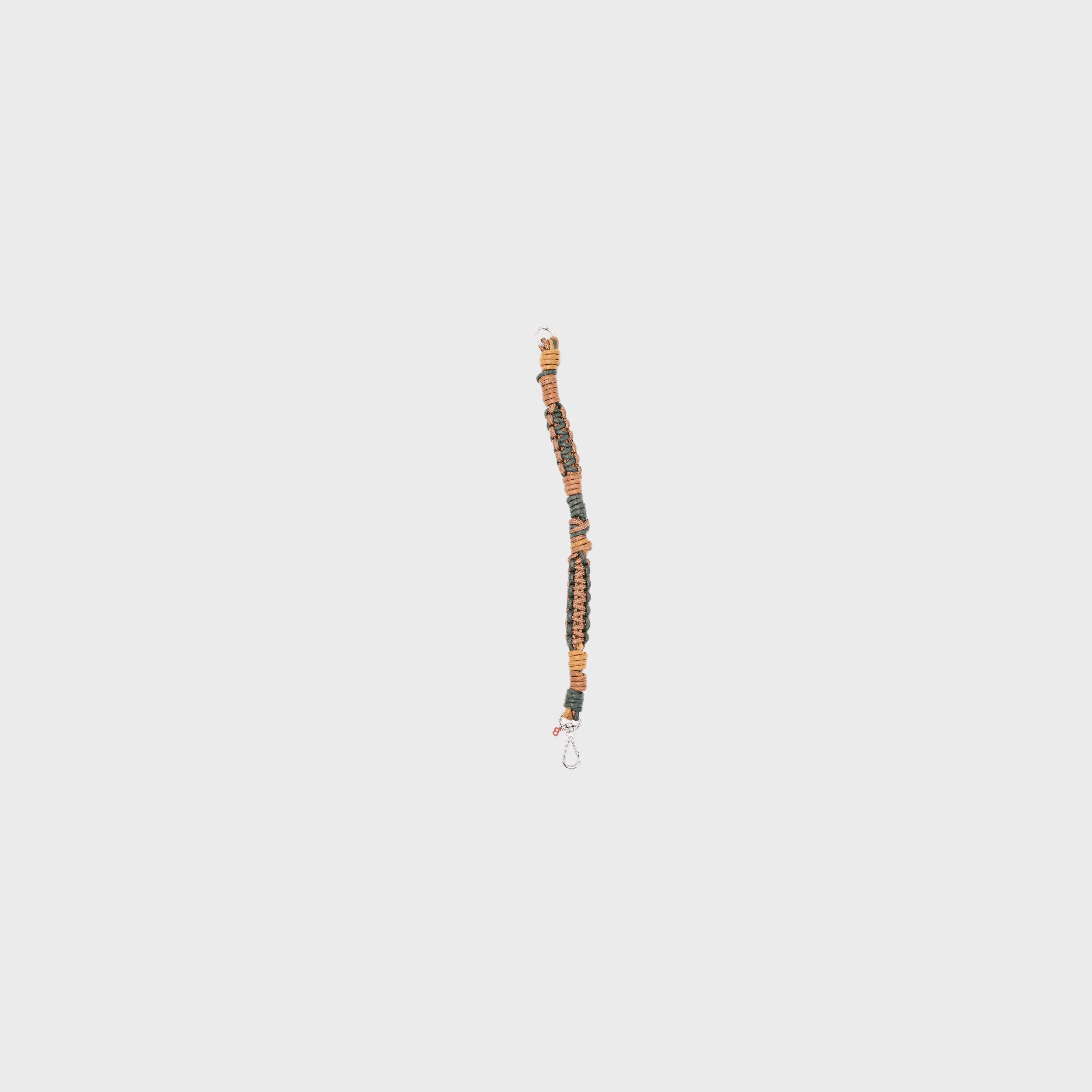 A braided macramé cord collar in shades of dark green and brown with a silver clasp.