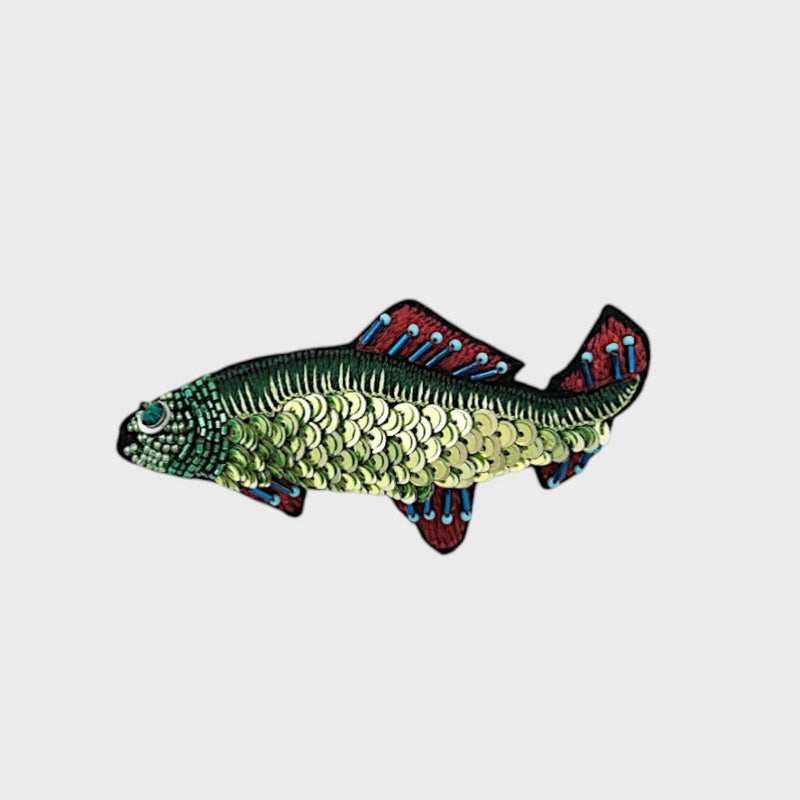 A embroidered green fish with blue and red details. 