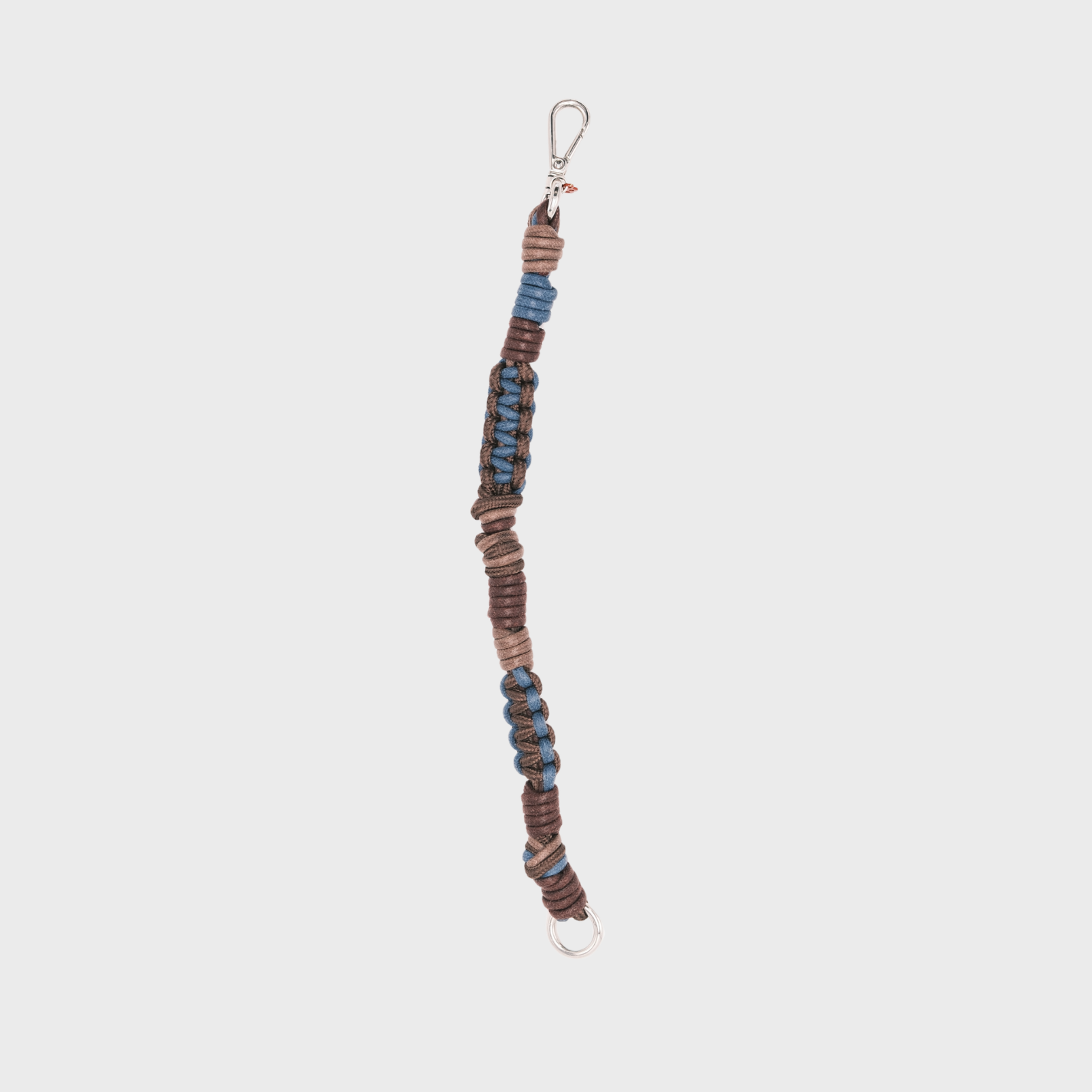 A handmade braided macramé cord collar in shades of brown and blue with a silver clasp.