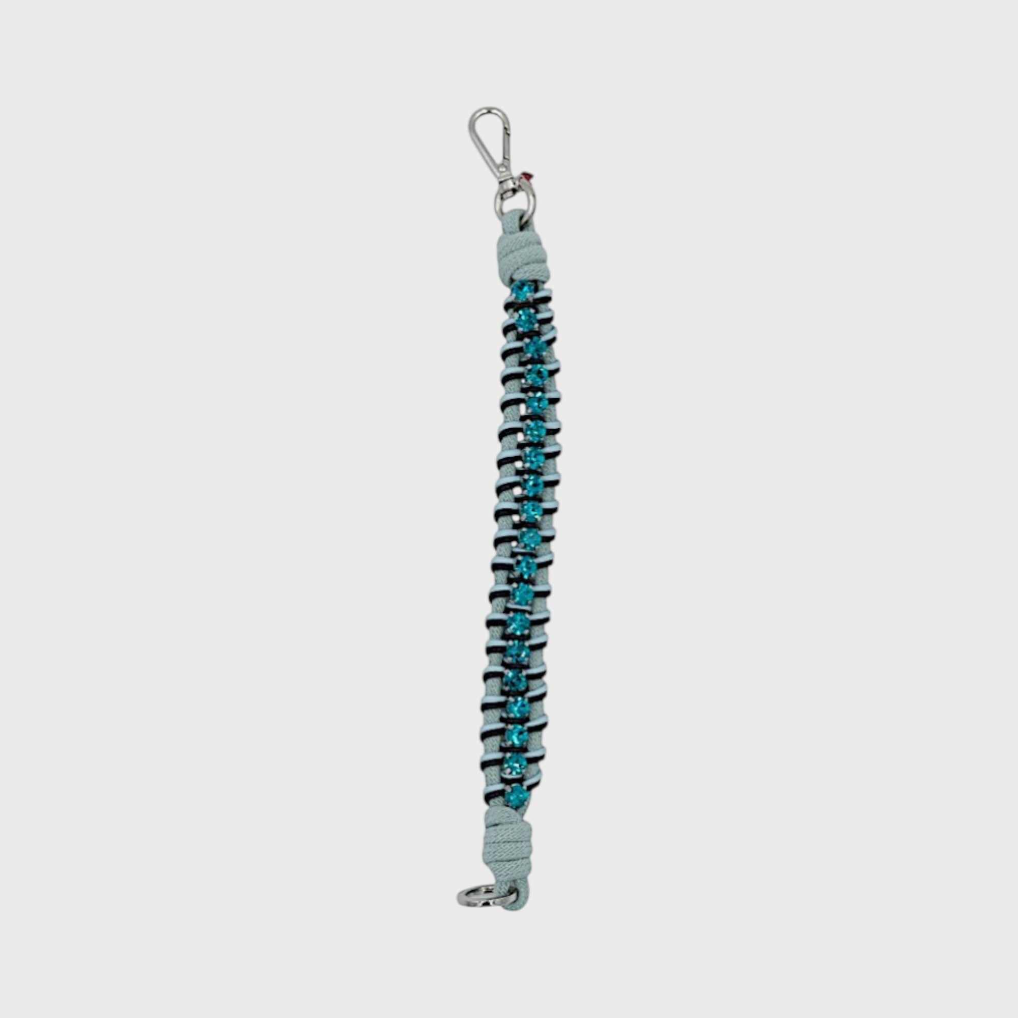 A braided macramé collar featuring light and dark blue cords with ocean blue beads and a silver clasp.