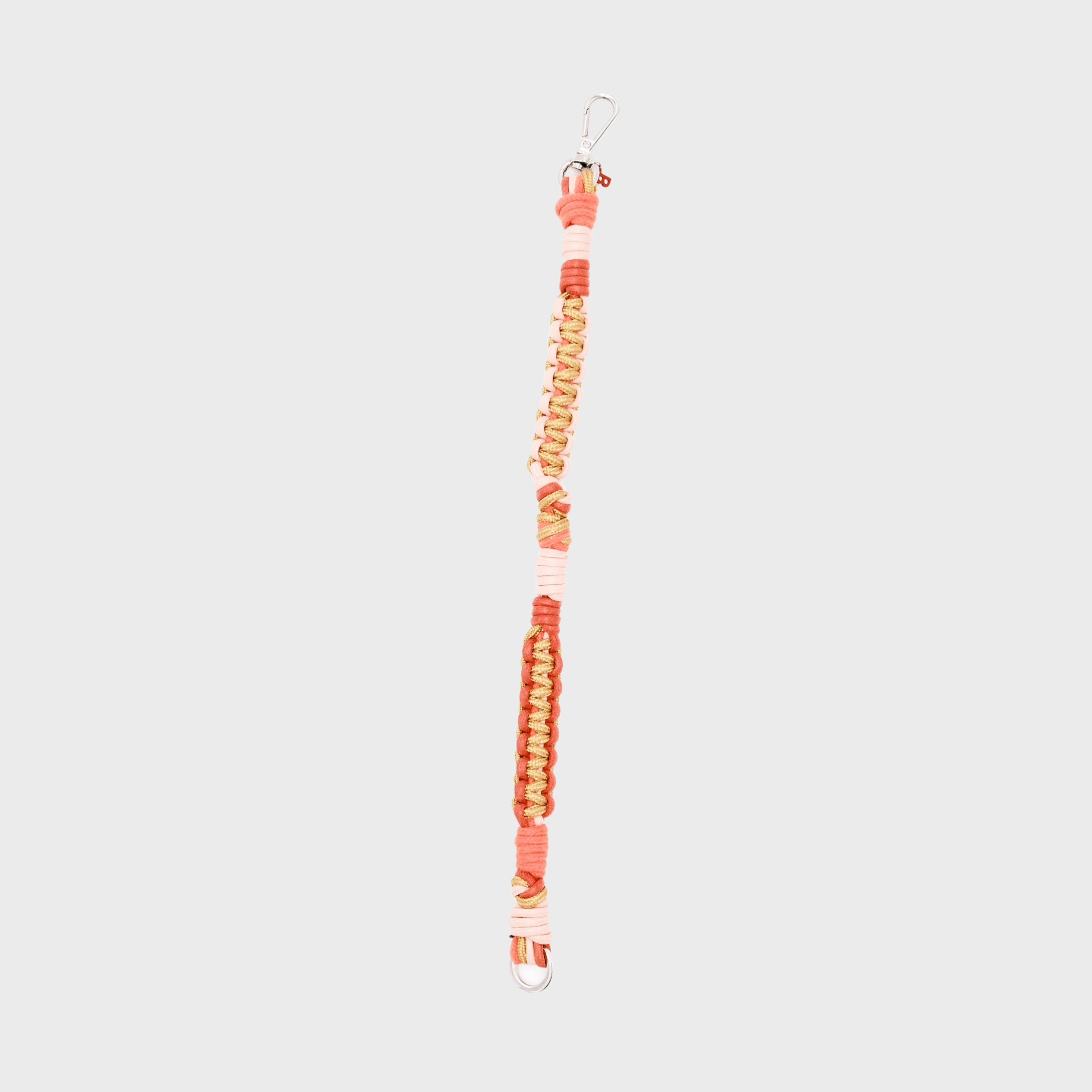 A braided macramé cord collar in shades of pink, peach, and beige with a silver clasp.