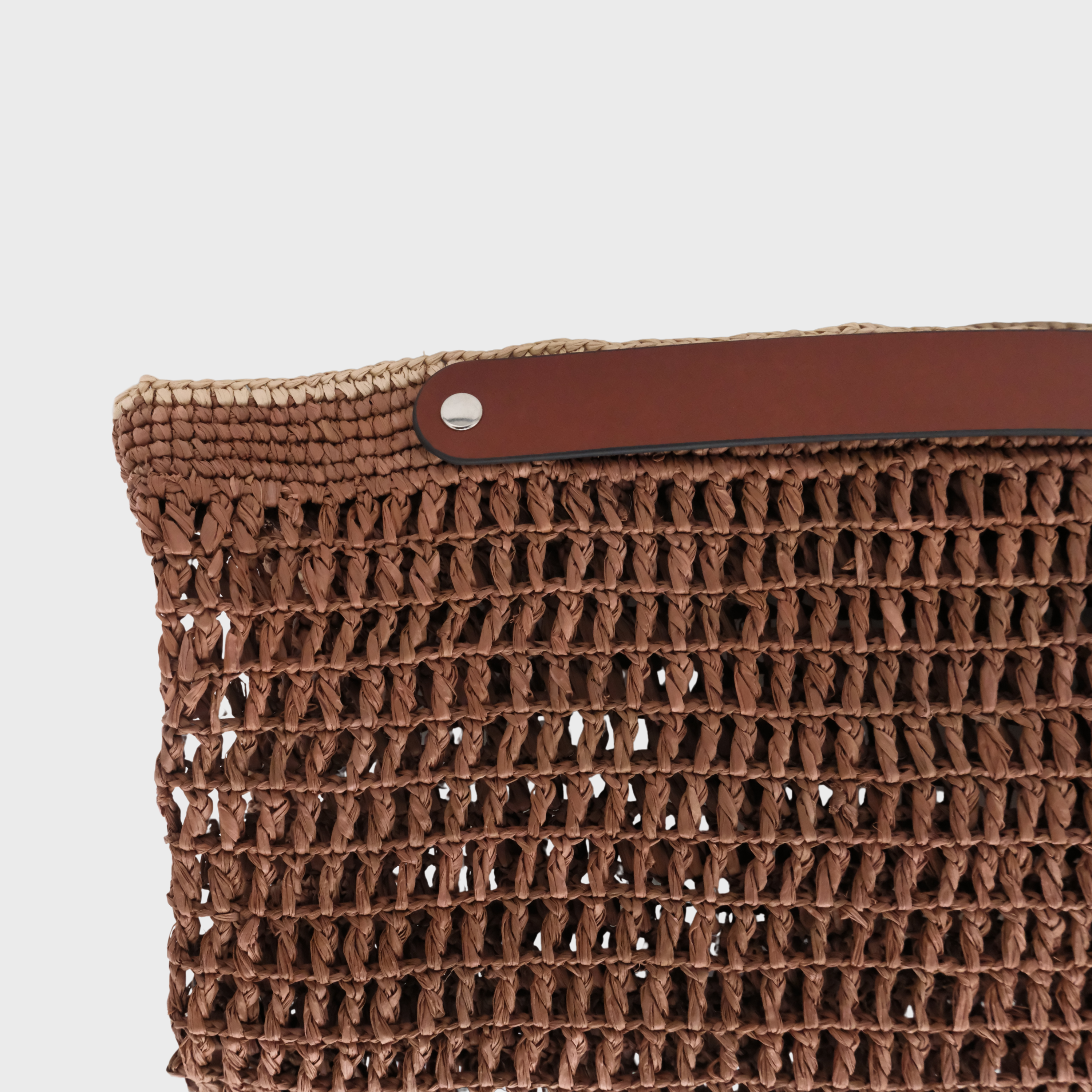 Focus on the square weaving of the raffia brown and beige Colin bag. 