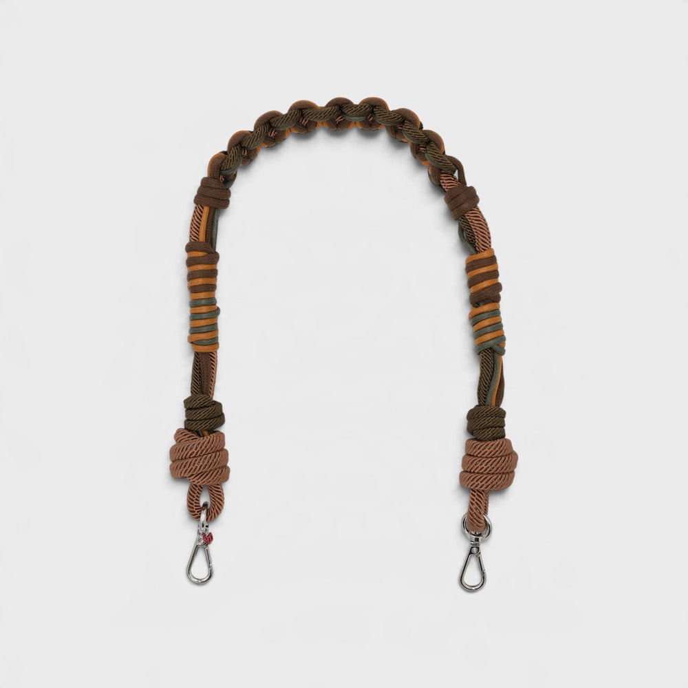 A brown and orange macramé bag strap with metal clasps, displayed on a light gray background.