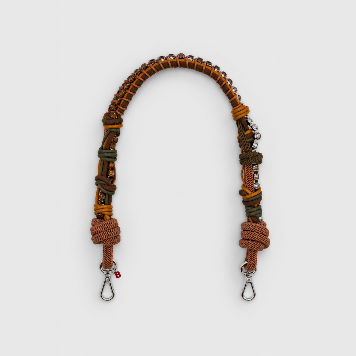 Multicolored braided macramé bag strap in dark green and brown, featuring some green colored beads and shown on a light grey background.