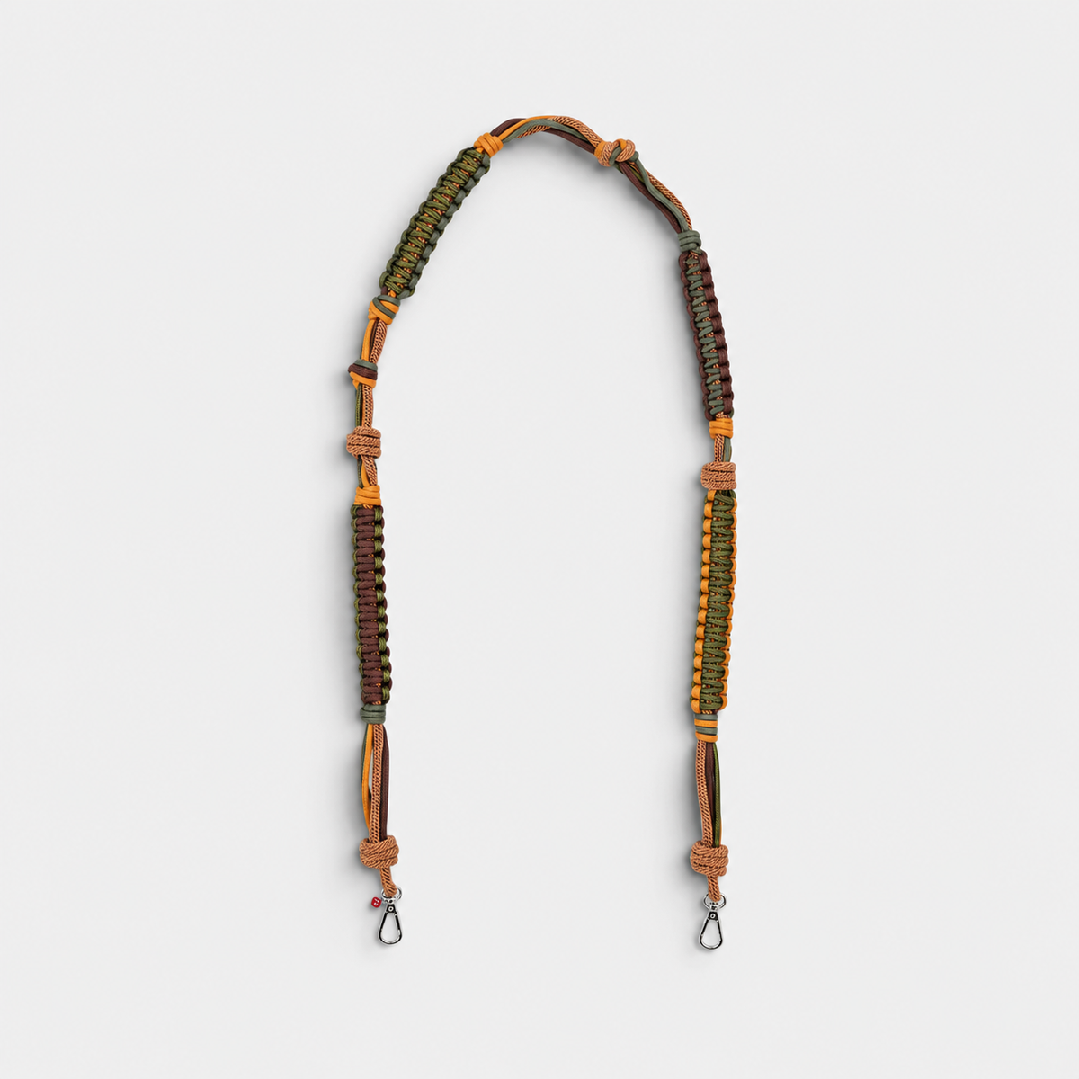 A macramé brown and green bag strap. 