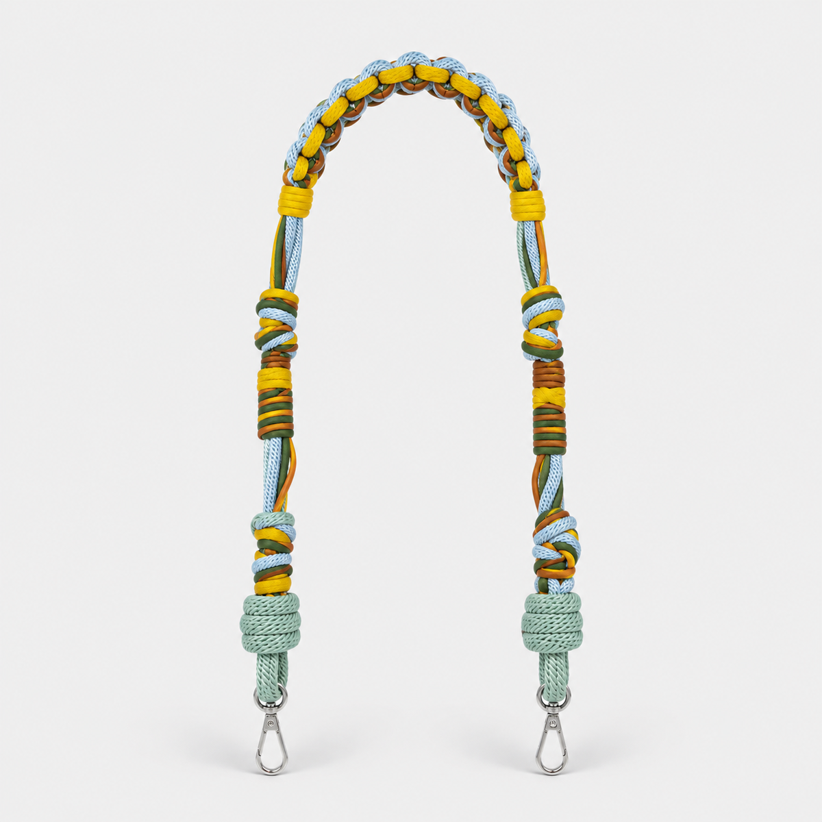 Multicolored braided macramé bag strap in yellow, light blue, and green with metal hooks on a light gray background.