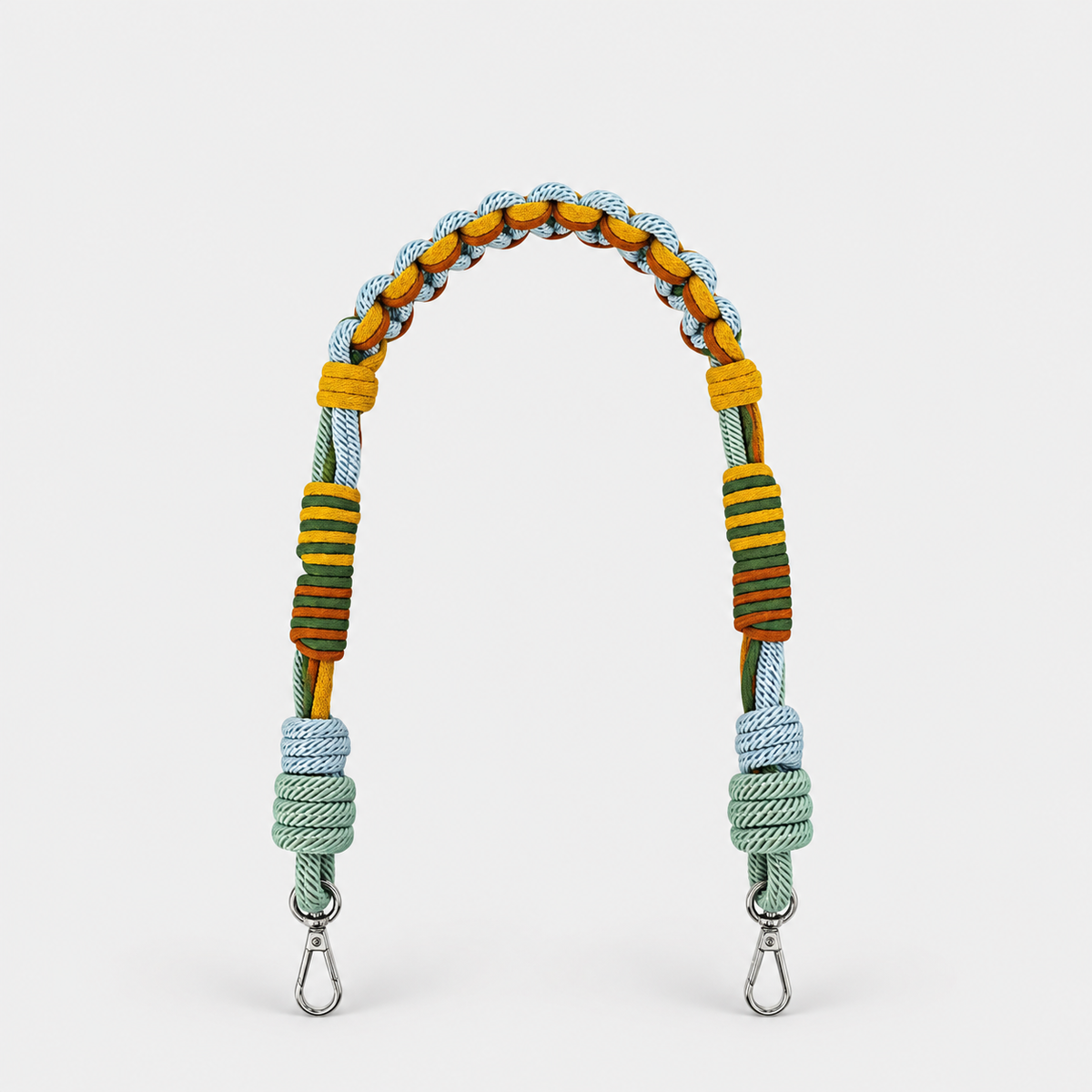 Multicolored braided macramé bag strap in yellow, light blue, and green with metal hooks on a light gray background.