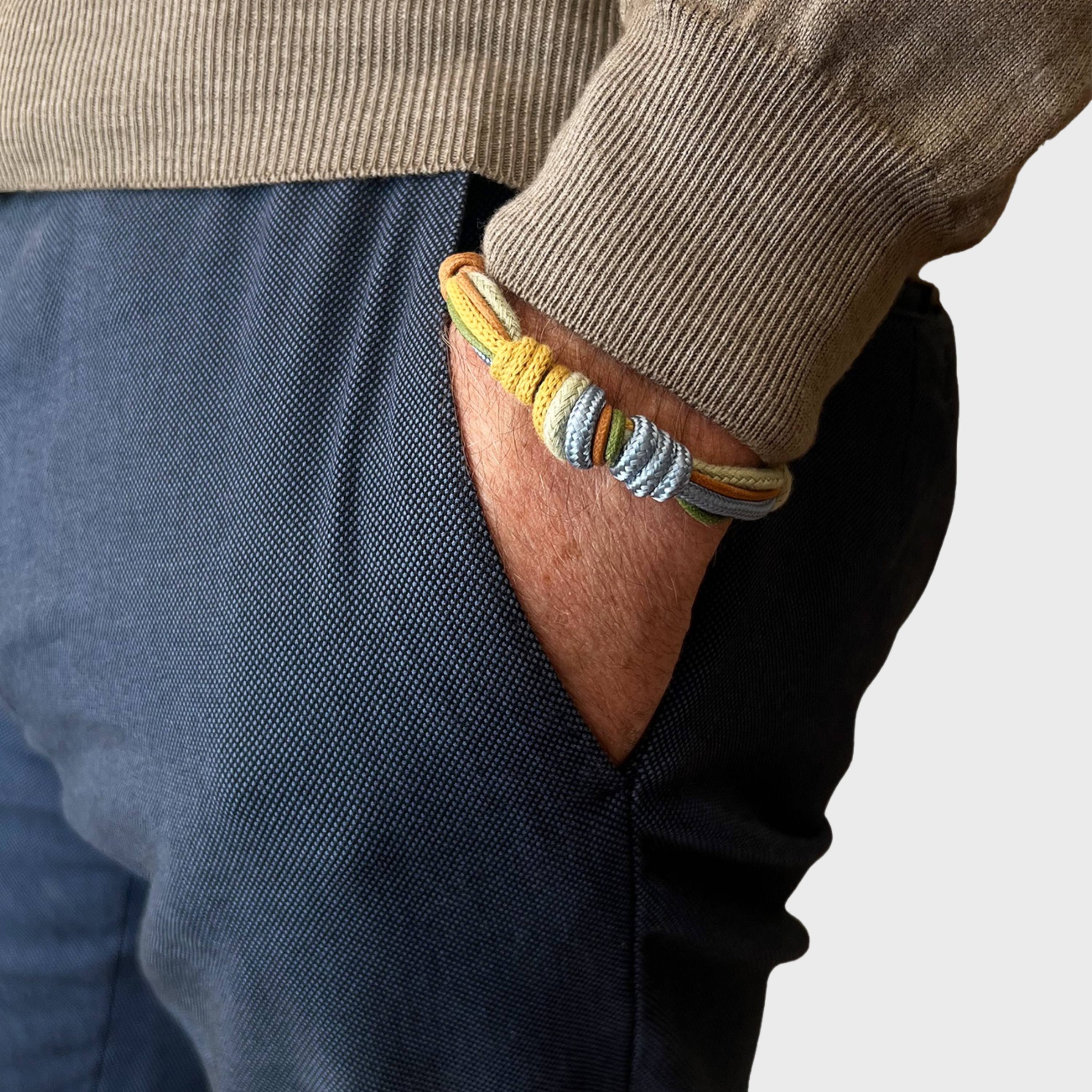 A model wearing the green, blue, brown and yellow knot bracelet