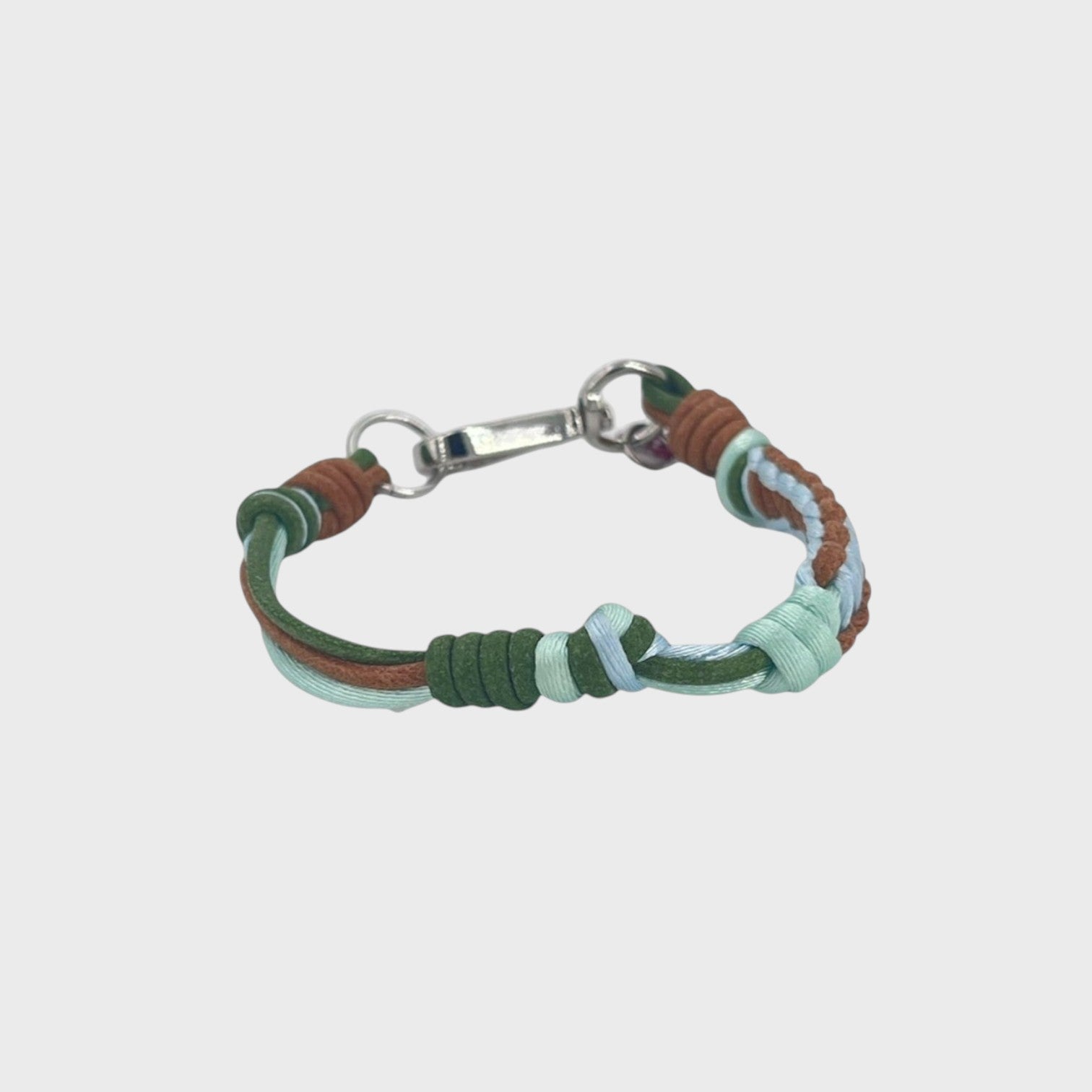 A thin braided bracelet with green, blue and brown macramé, featuring a silver metal  clasp. 