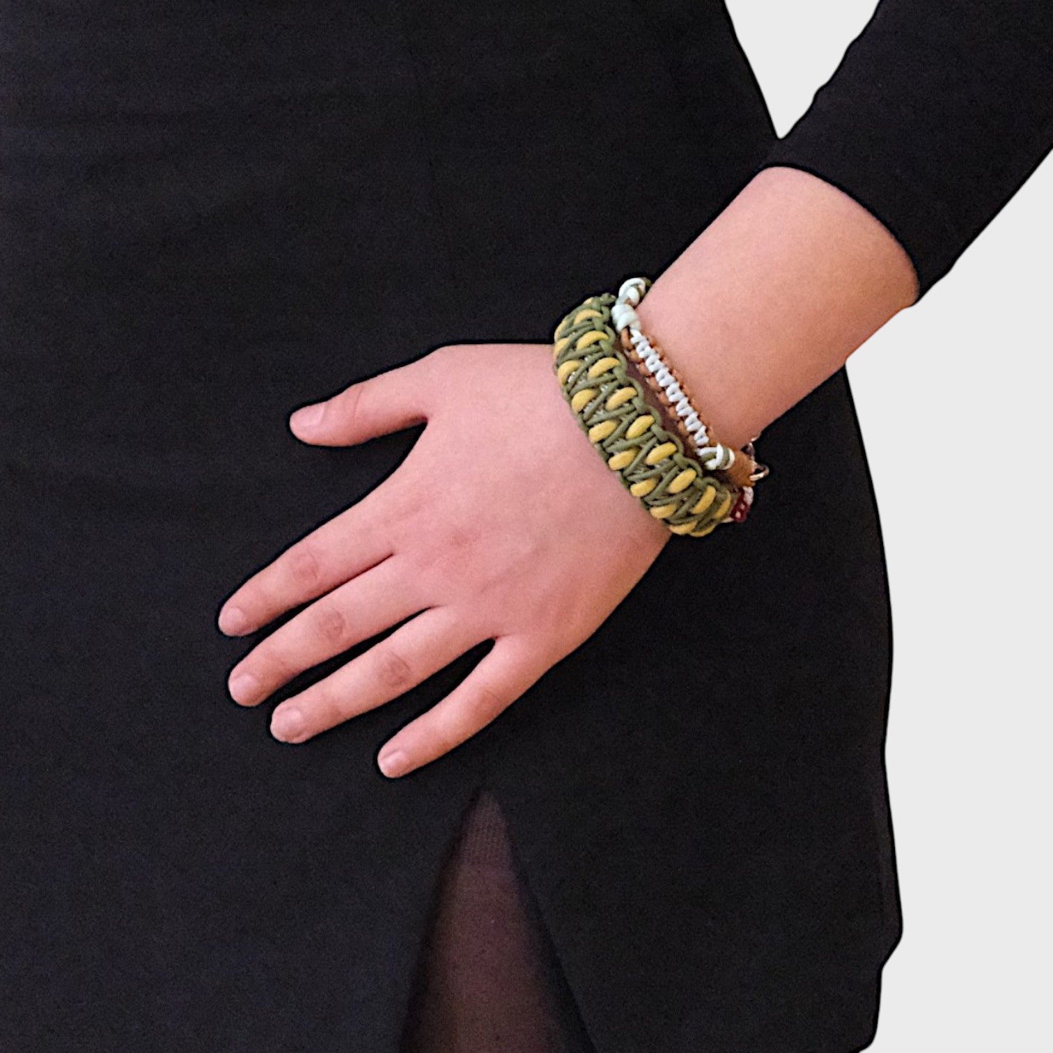 A model wearing several bracelets including the green, brown and blue Nino bracelet