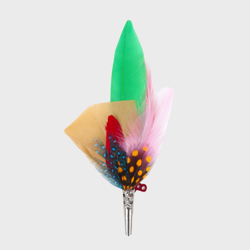 Pink, green, red and beige feathered brooch on a light gray background