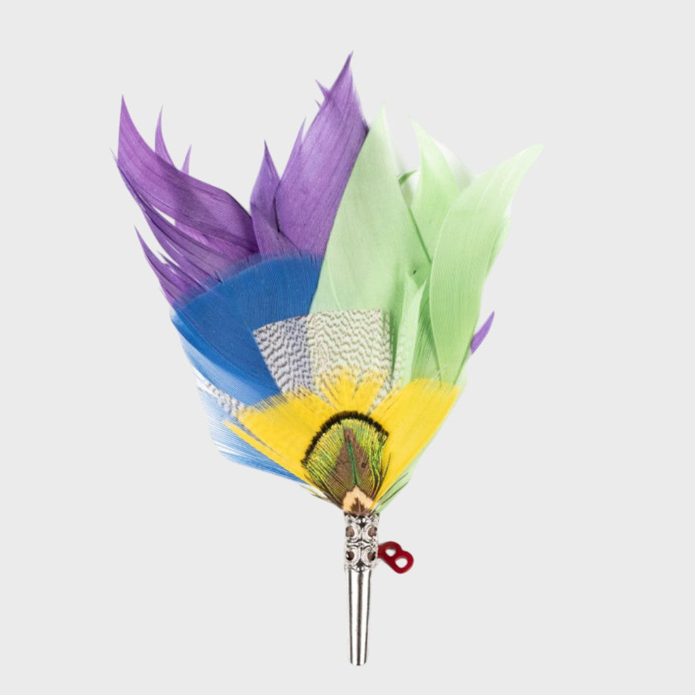 Purple, blue, green and yellow feathered brooch on a light gray background