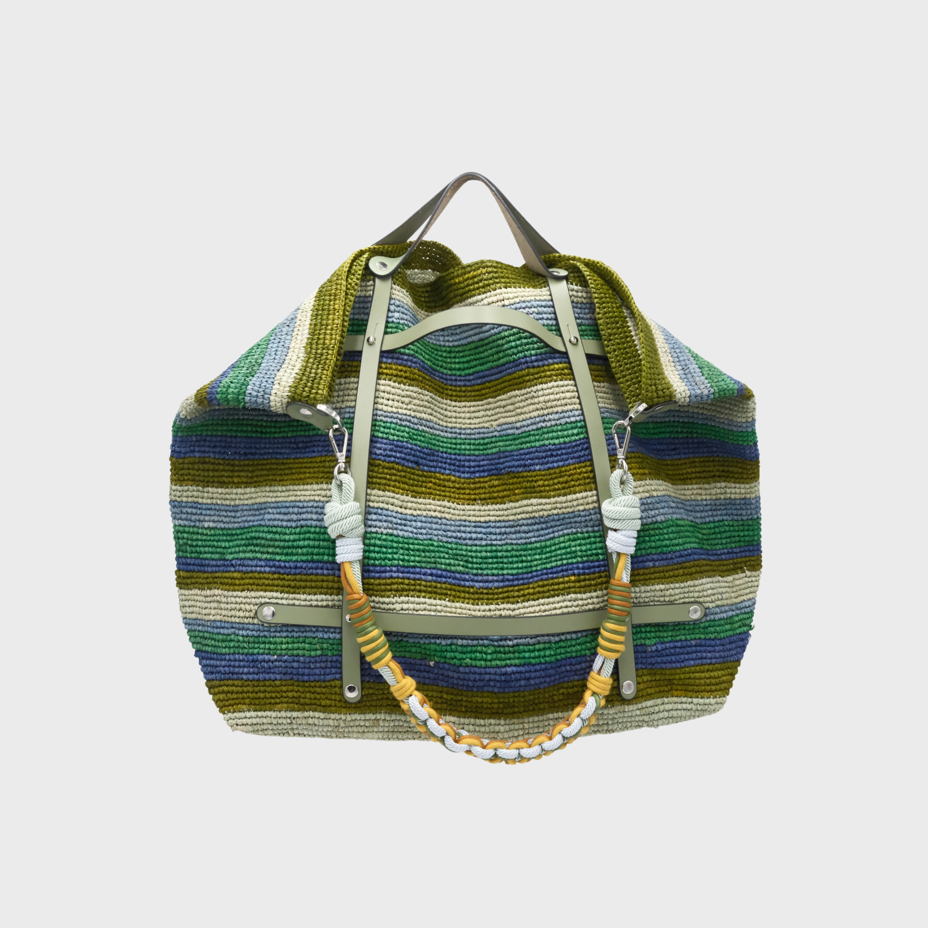A woven weekender with horizontal stripes in various greens, and blues. Paired with a colourful lightt blue, yellow and green shoulder strap and a light green leather harness.