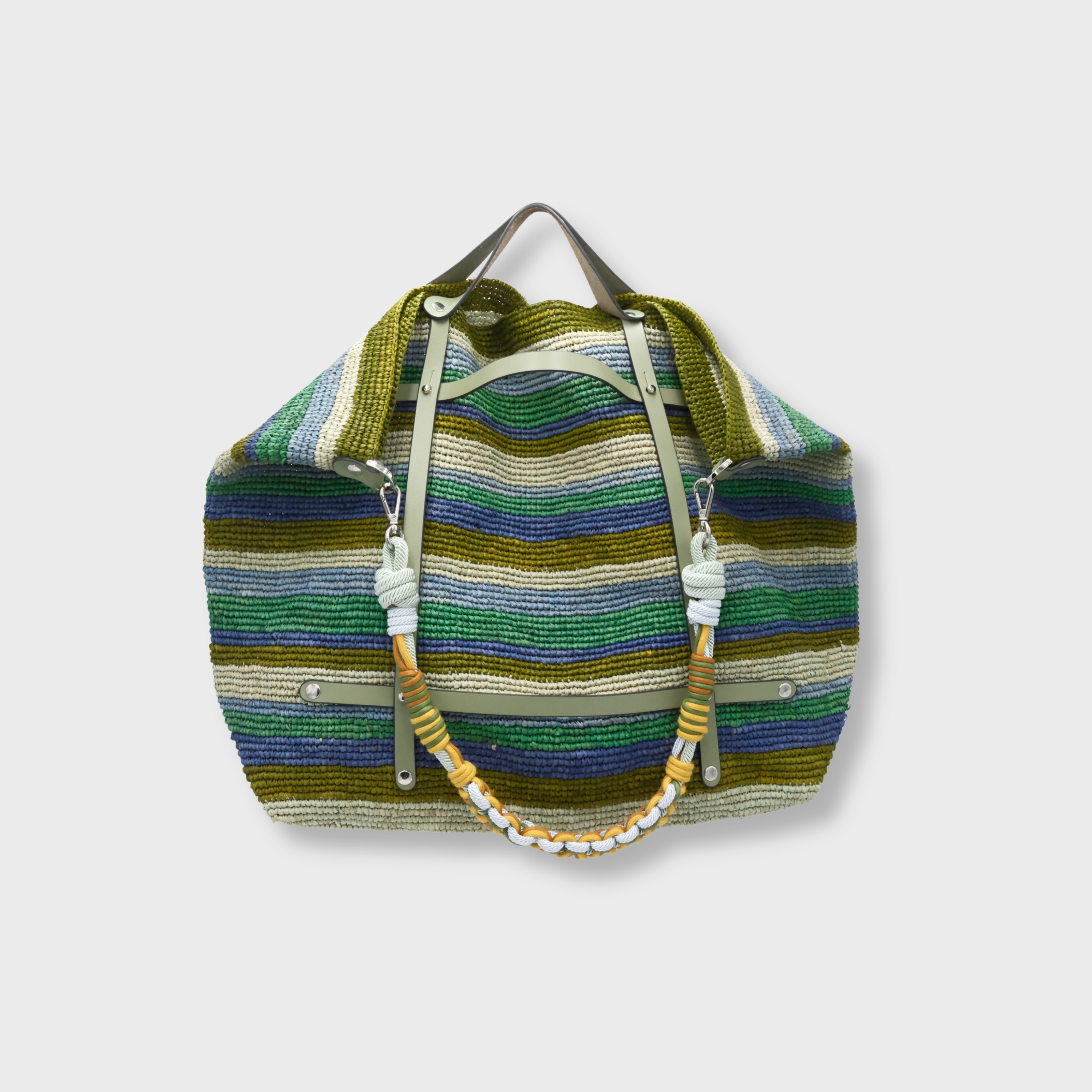 Blue, green and beige striped raffia weekend or duffle bag with a green leather harness, paired with a colourful shoulder strap in green, yellow, blue and brown.
