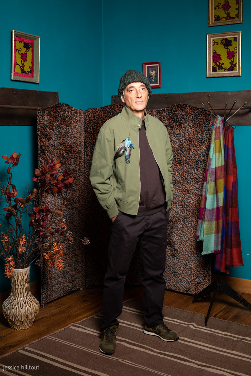 A man wearing a green hand-knitted bonnet. 