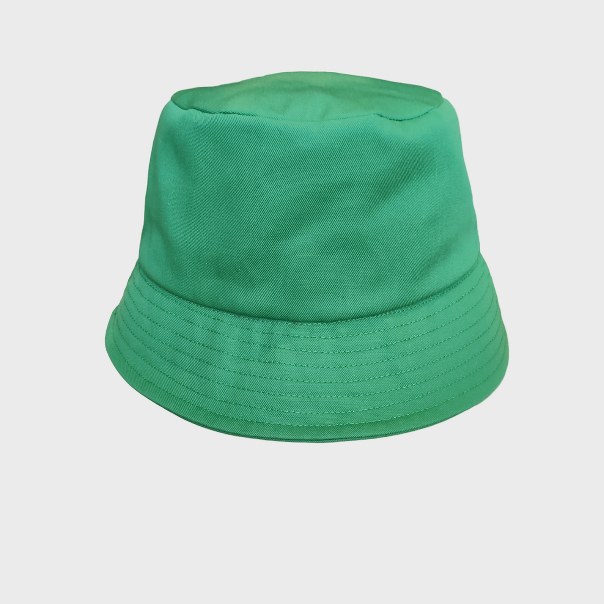 Green cotton bucket hat on a light gray background