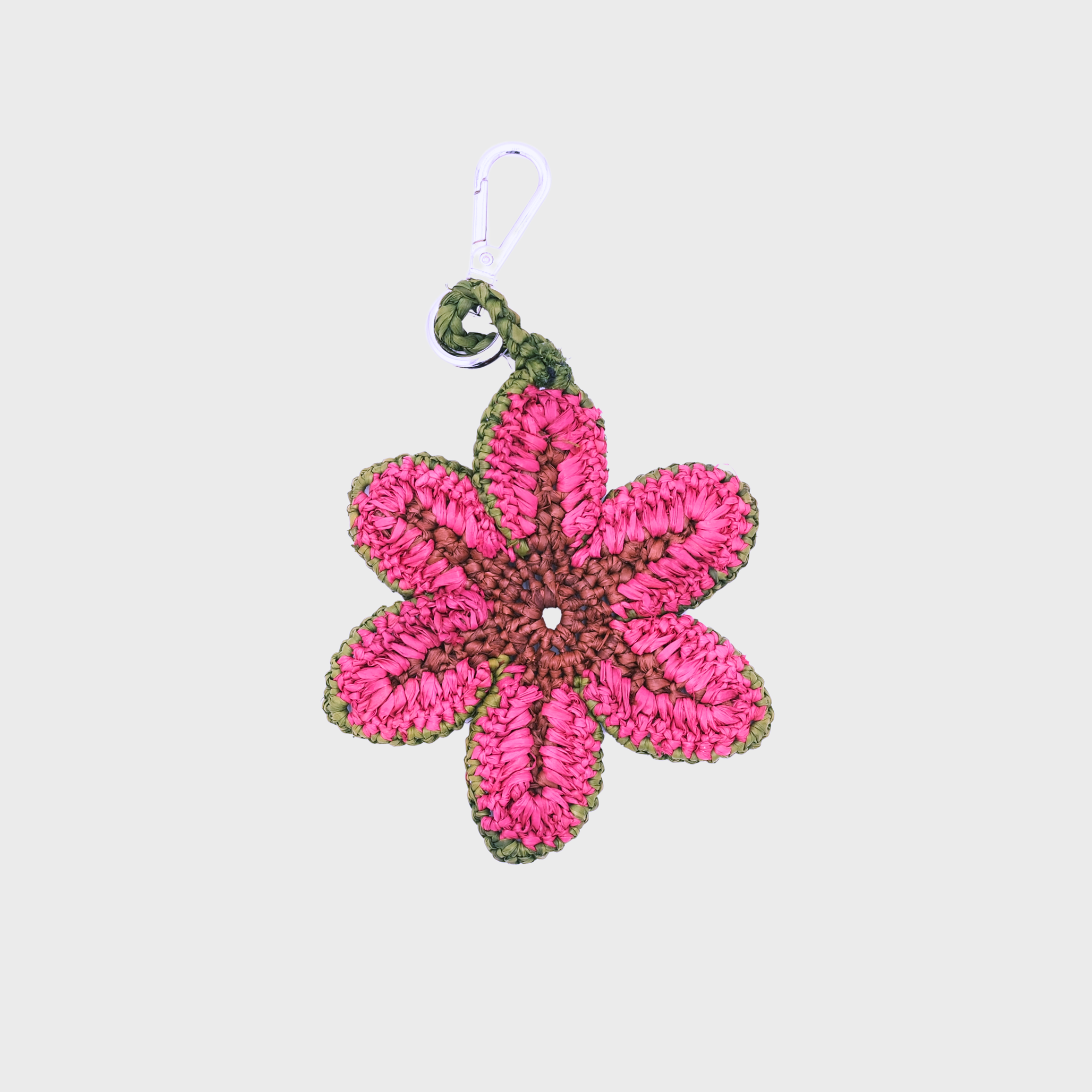A pink raffia flower keychain and olive green border, with a silver metal clasp.