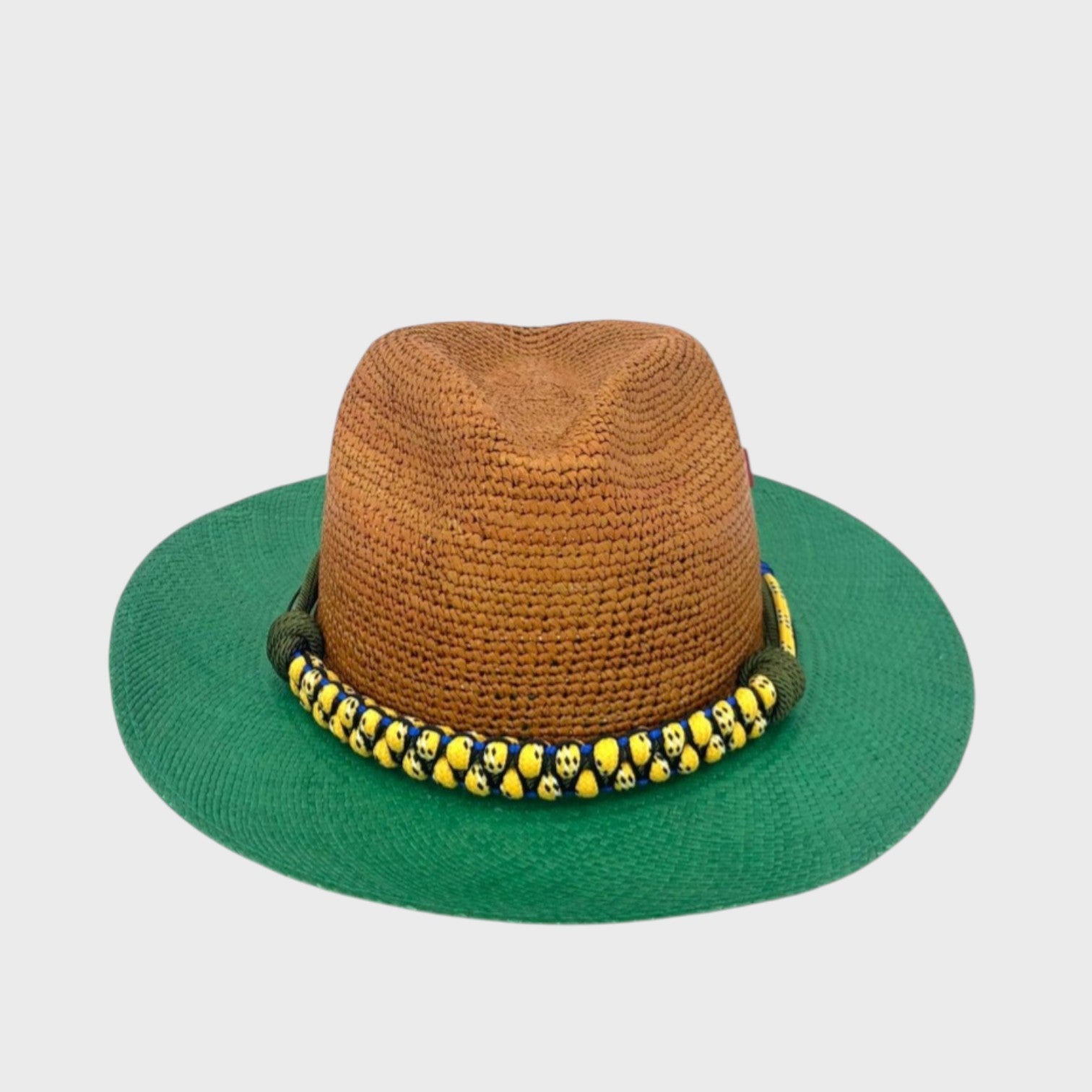 A brown and green raffia hat with a yellow macramé woven hat band around it. 