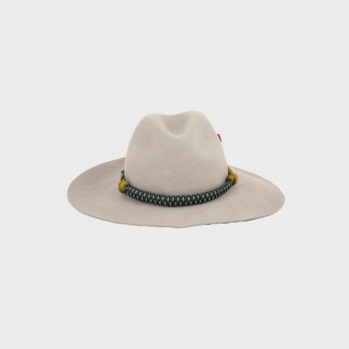 Beige wool hat shaped as heart with decorative band on a light gray background