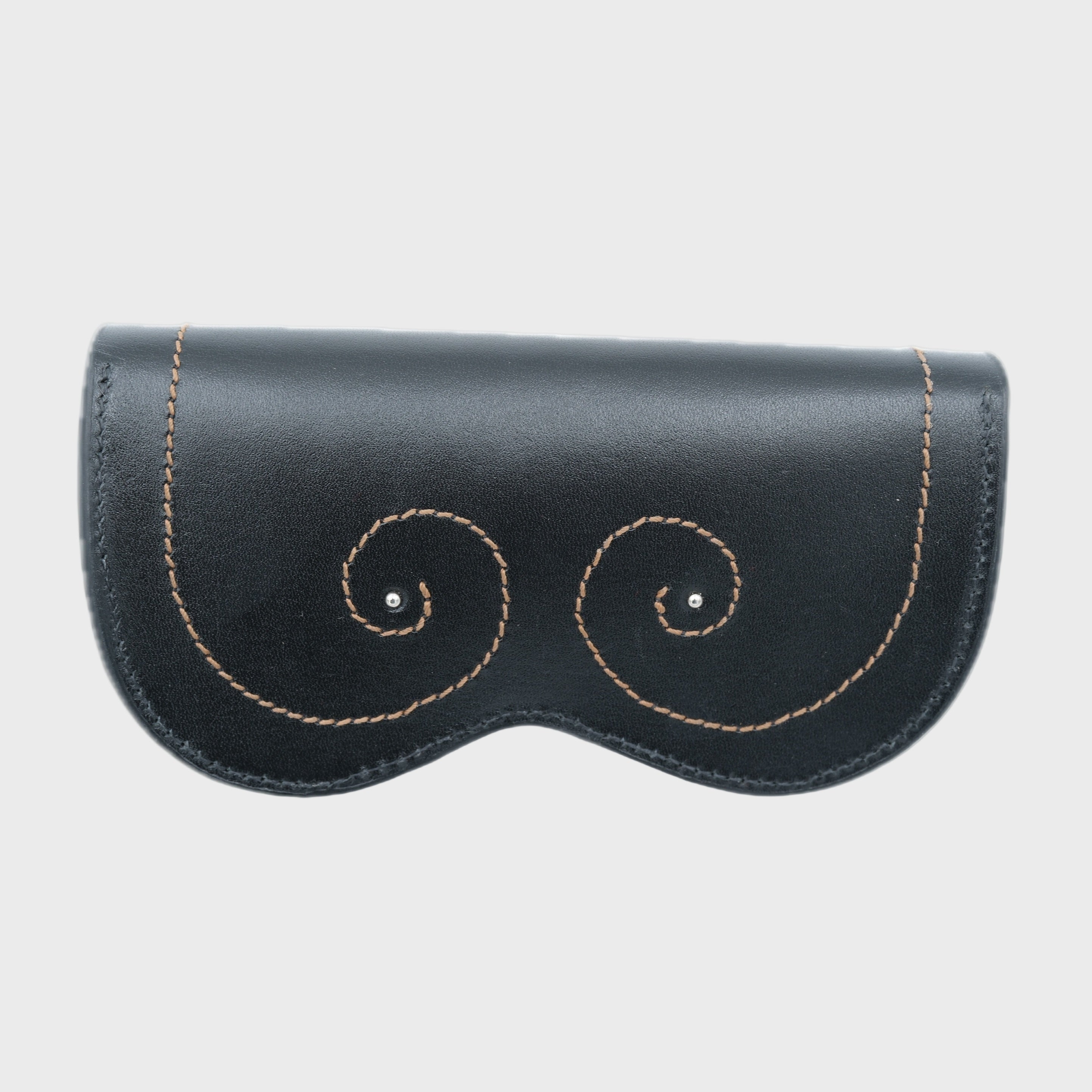 A black leather glasses case with small golden embroidered curves on it. 