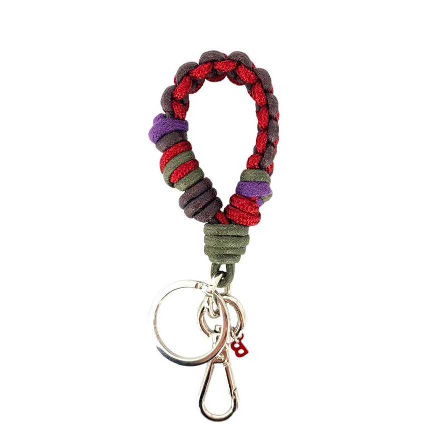 A braided macramé keychain or bag clip in pink, brown, dark green and purple, featuring a silver metal clasp. 