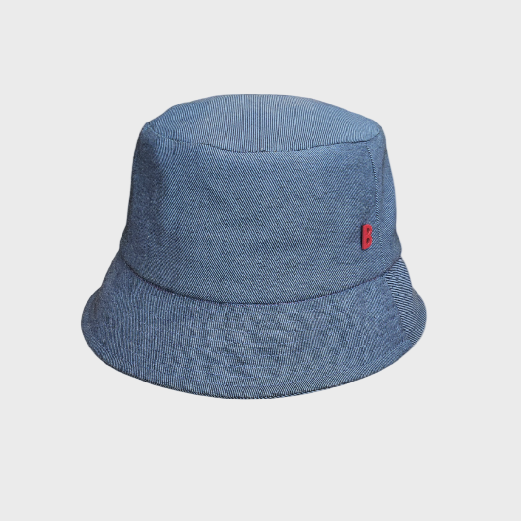 Blue jean bucket hat with a red tag on a light gray background