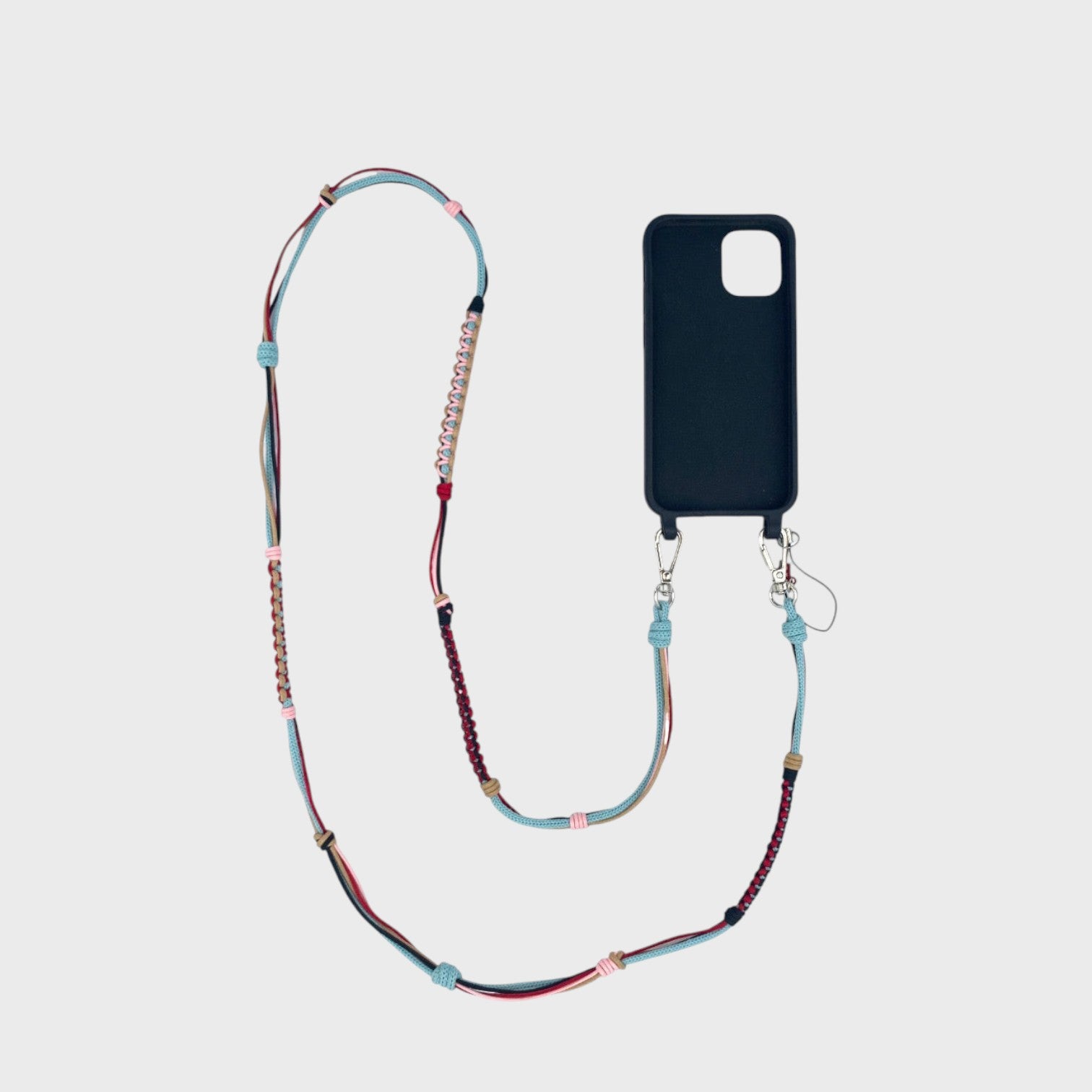 Neon light blue, light pink, red and brown macramé woven phone lanyard with a black phone case on a white background. 
