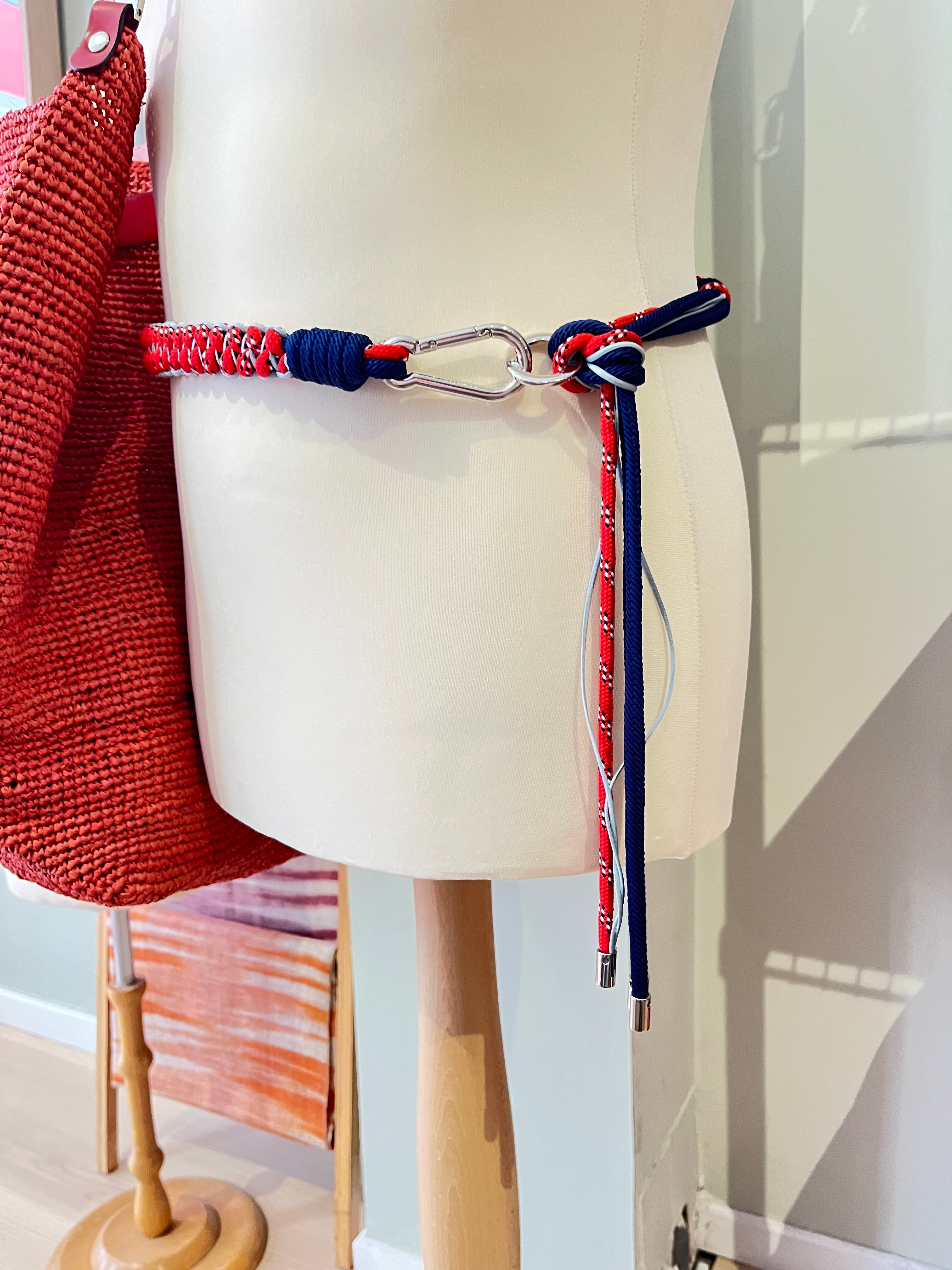 Mannequin showed with the red, navy, and white macramé belt.