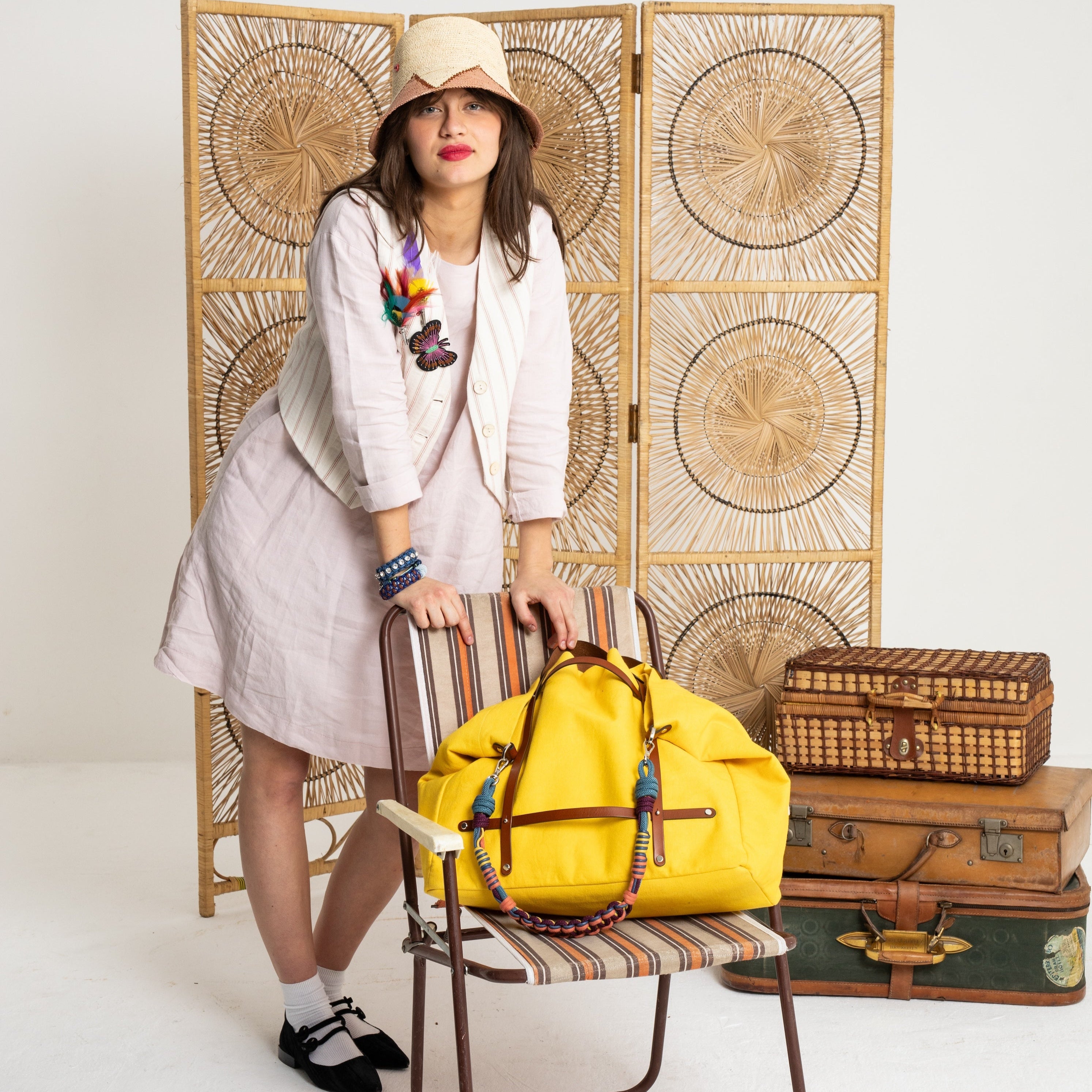 Model showing the bright yellow canvas weekend or duffle bag on a chair.