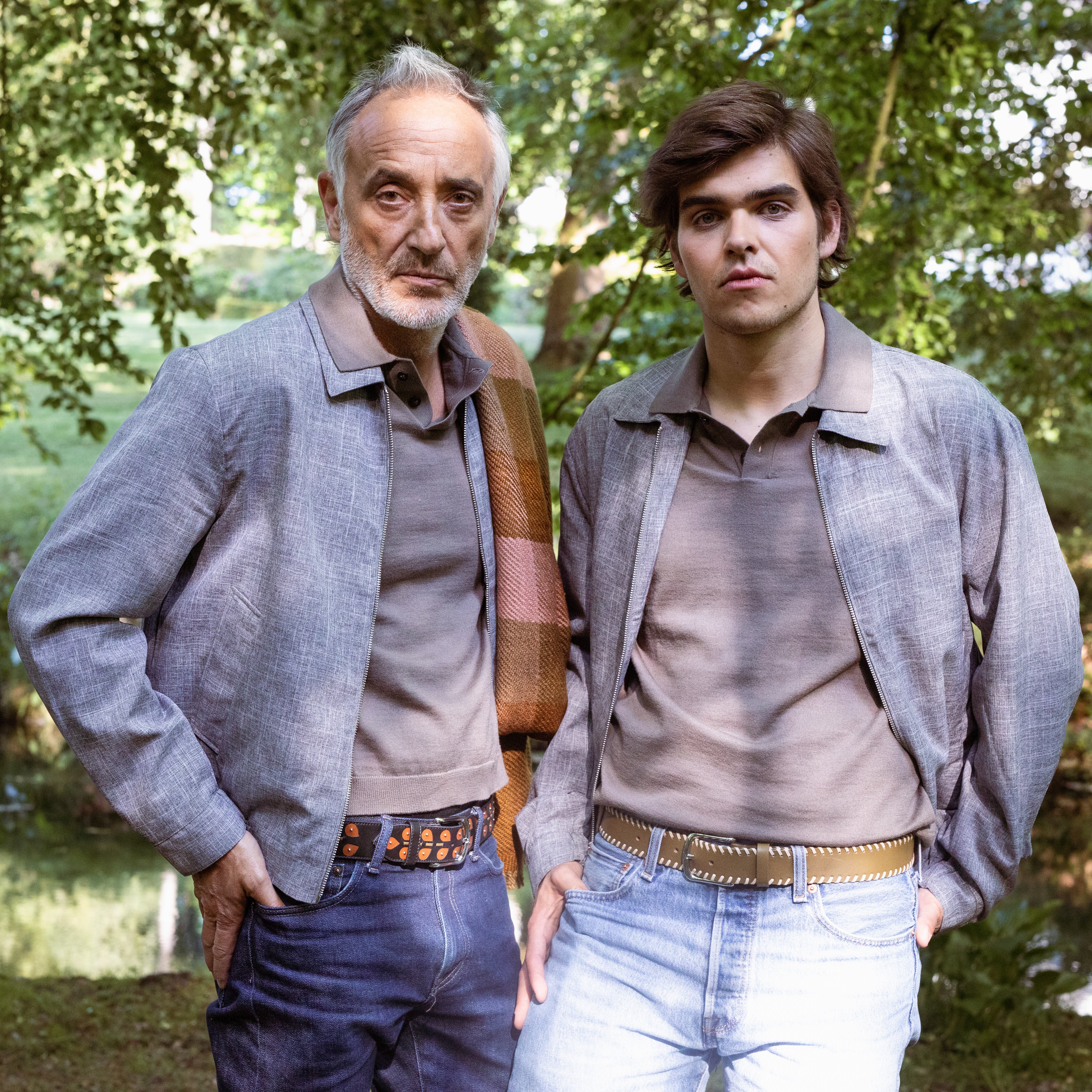 Two models wearing MY BOB leather belts outdoors, including the Black Leaves belt